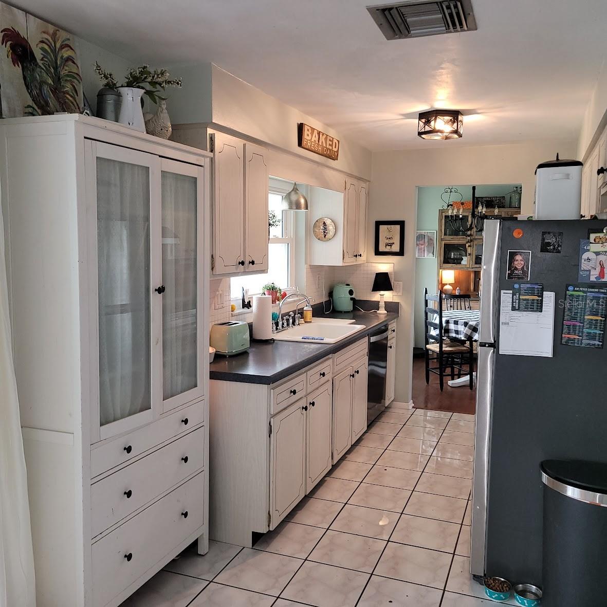 The opposite view of the kitchen. The 3 drawer storage cabinet seen on the left side of the photo does not convey, sorry!