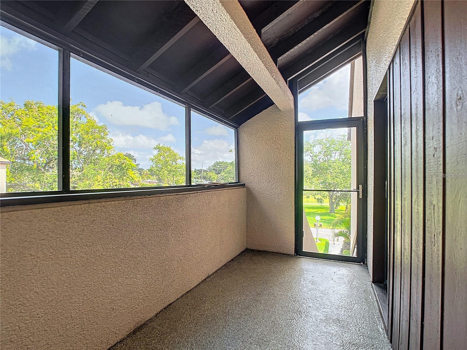 Upon ascending the stairs to the townhouse, you'll be greeted by a charming screened porch. From this peaceful retreat, you can enjoy captivating views of the pond and golf course.