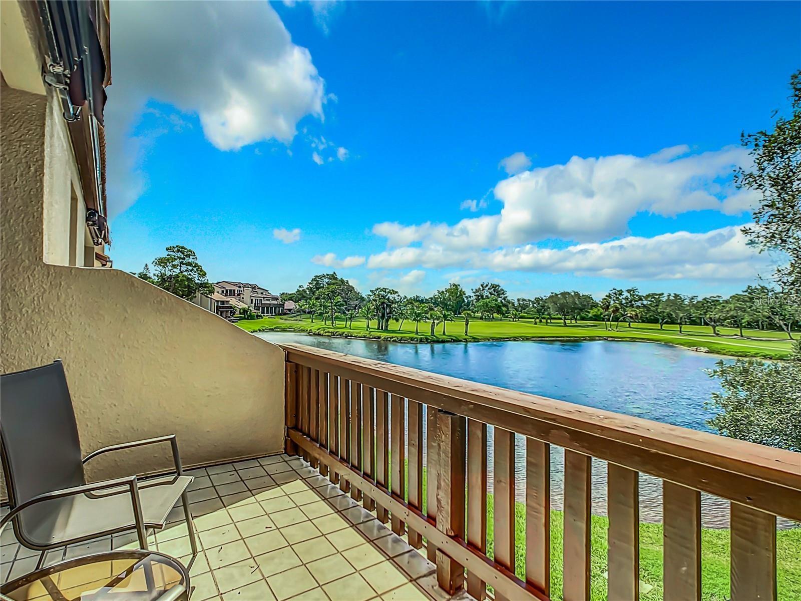 From the balcony, enjoy expansive views of the serene pond and the lush fairways of the golf course, offering a picturesque and tranquil setting.