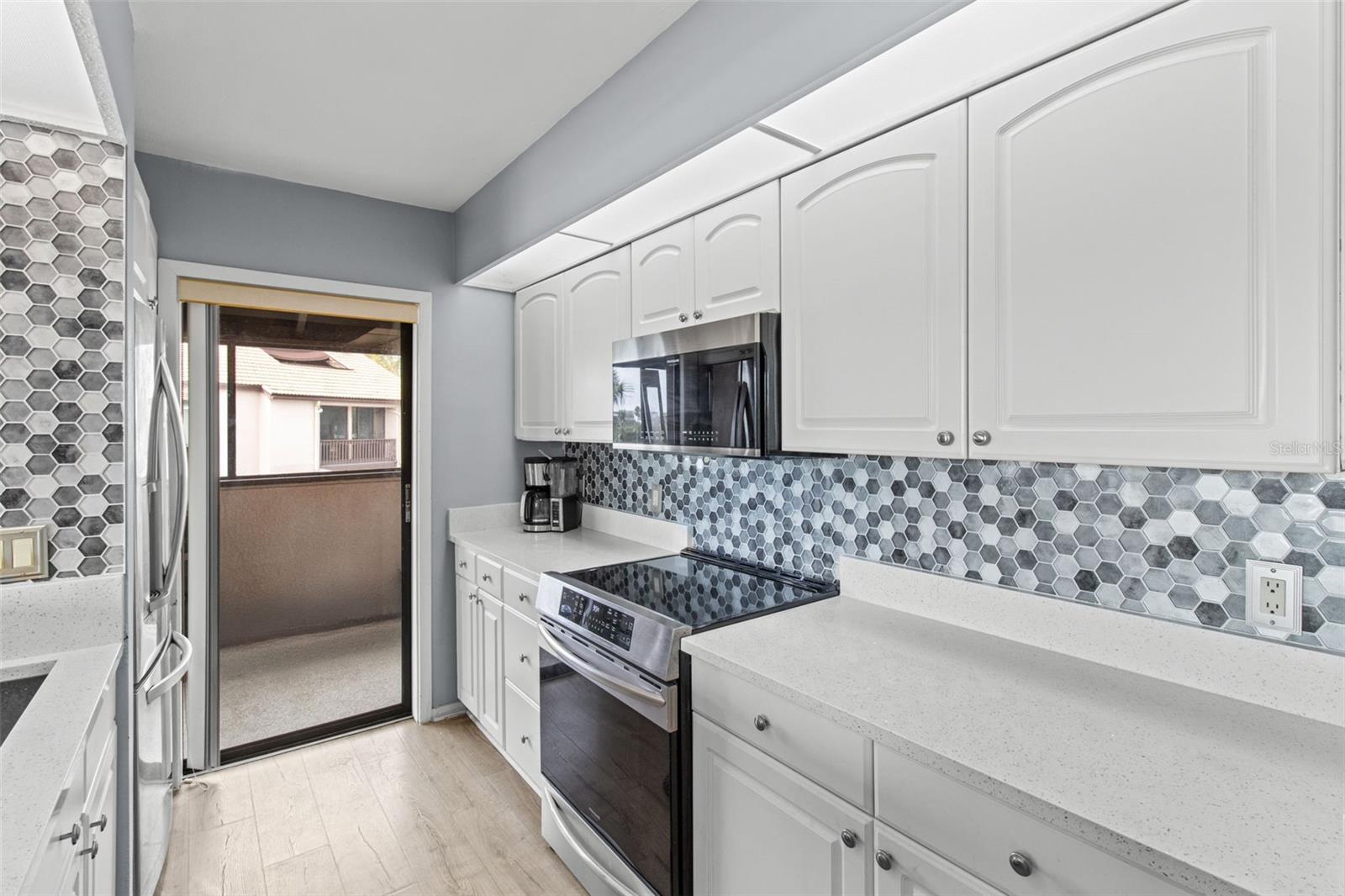 The kitchen features stainless appliances. and plenty of counter space.