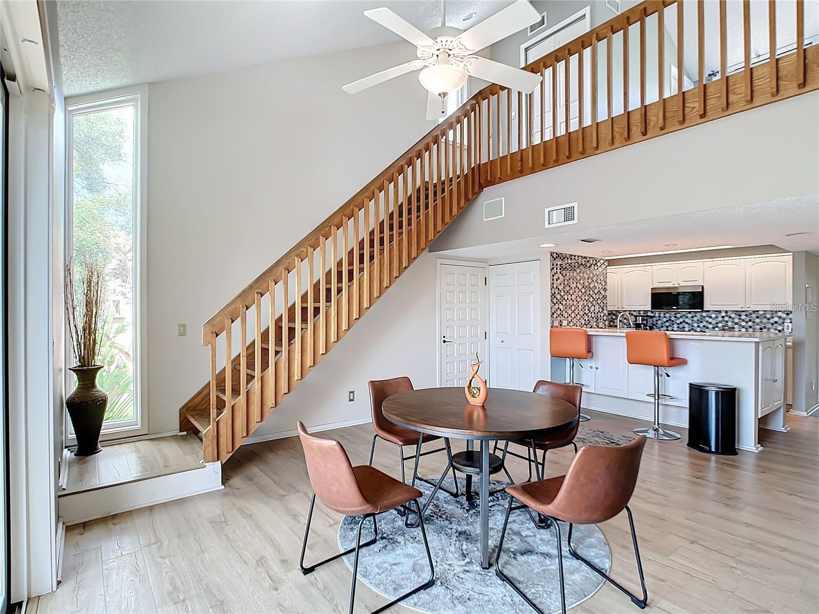 The elegant wooden staircase leads you to the spacious second primary suite, which boasts a generous walk-in closet and a private full bathroom, offering both comfort and privacy