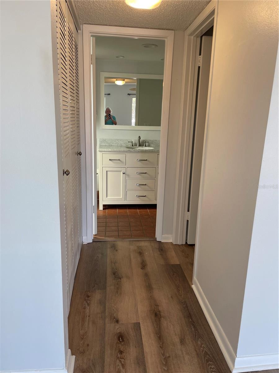 Primary bath and hall with closets