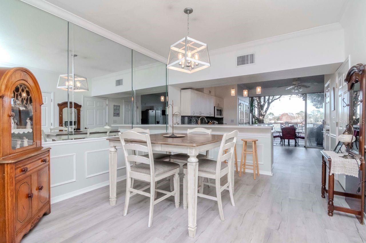 View of dining area into kitchen and back dock.