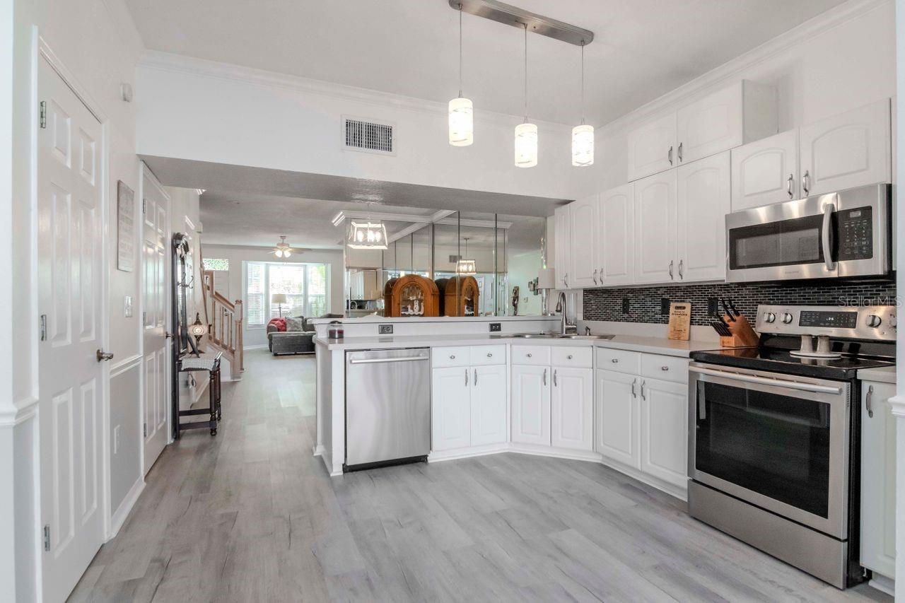 Kitchen with new flooring, large pantry and laundry closet.