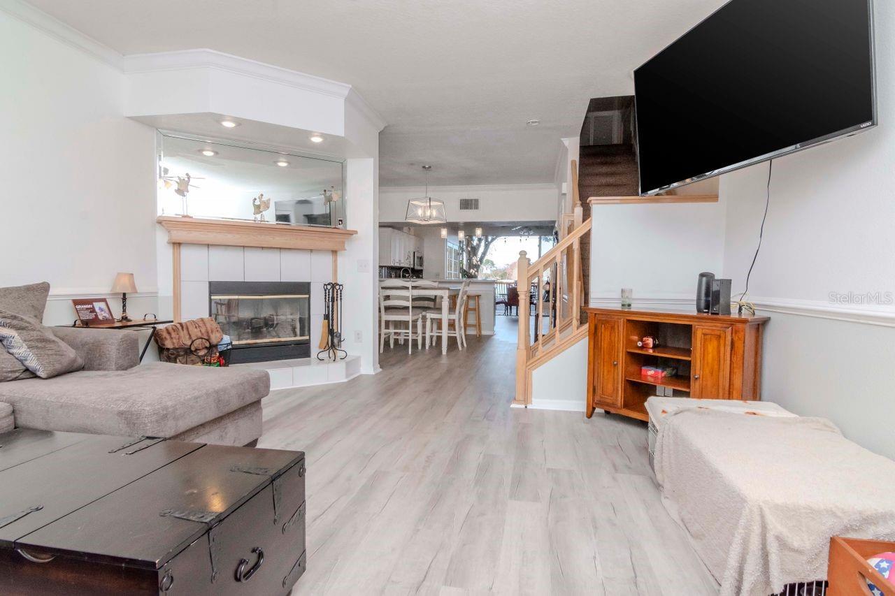 Living room with wood burning fireplace & new LTV flooring