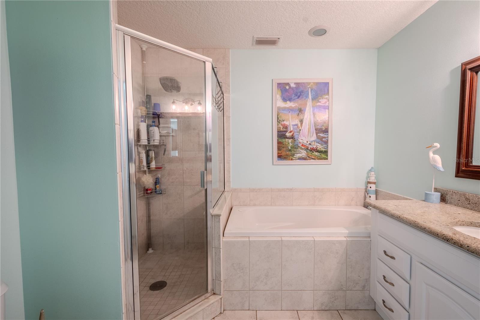 The primary bath features a step in shower and a ceramic tile floor.