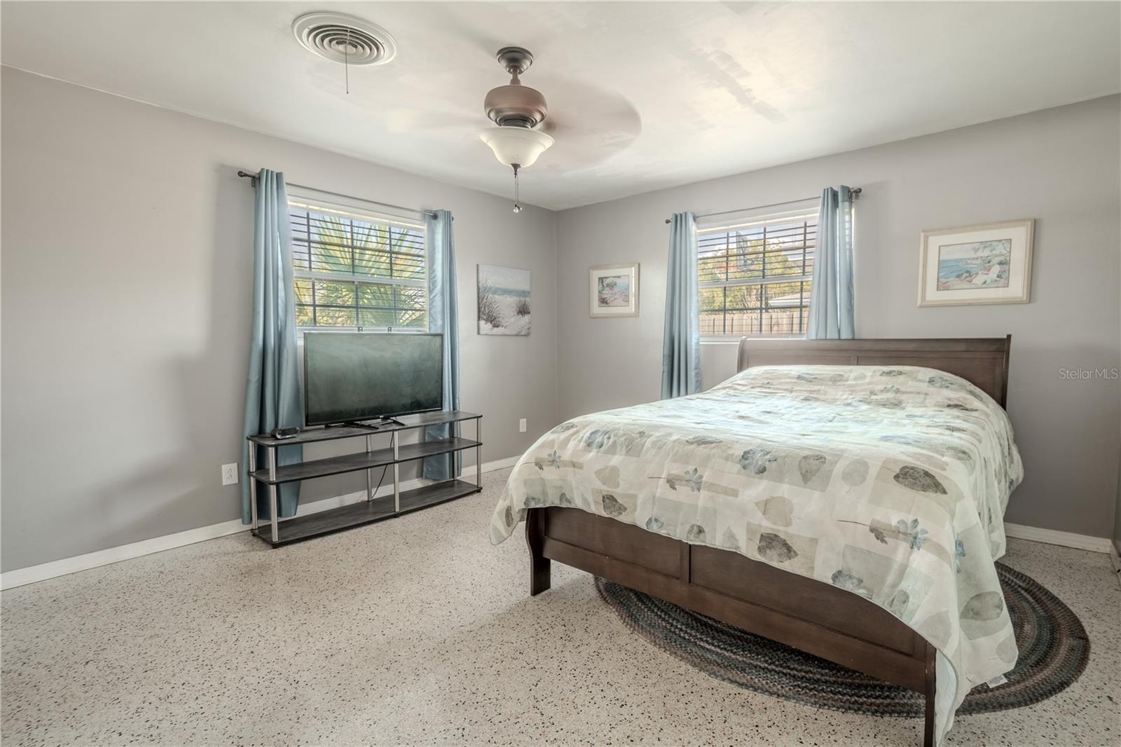 Bedroom 3 features terrazzo floor, a built in closet and a ceiling fan with light kit.