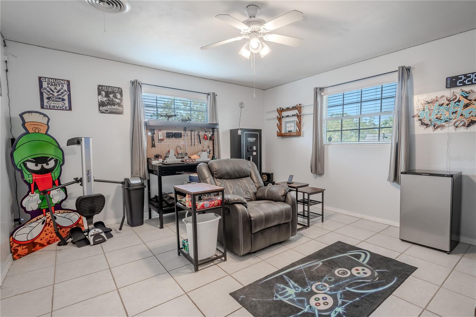 Bedroom 2 features tile floor, a built in closet and a ceiling fan with light kit.