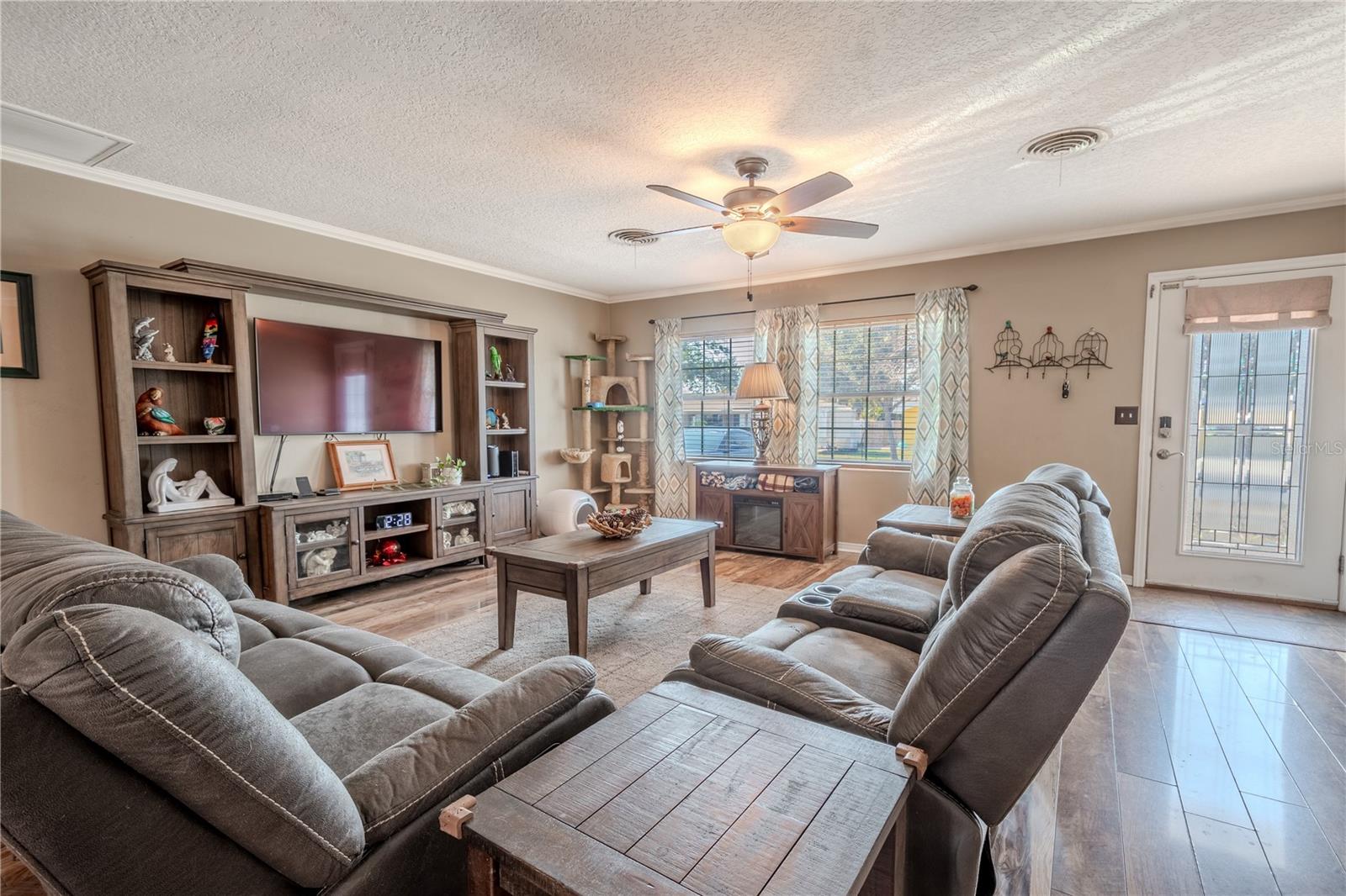 The living room features crown molding, a picture window and a beveled glass front door.