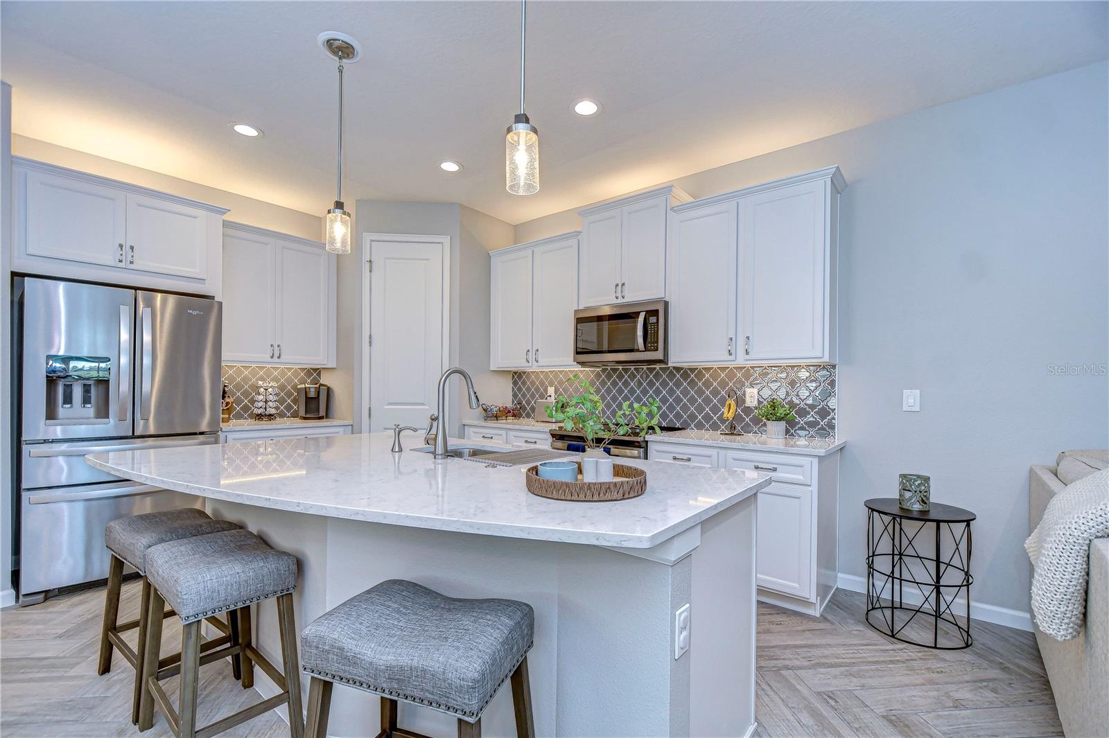 Expansive island with breakfast bar, statement lighting, under and top cabinetry lighting ensure that no detail was overlooked!