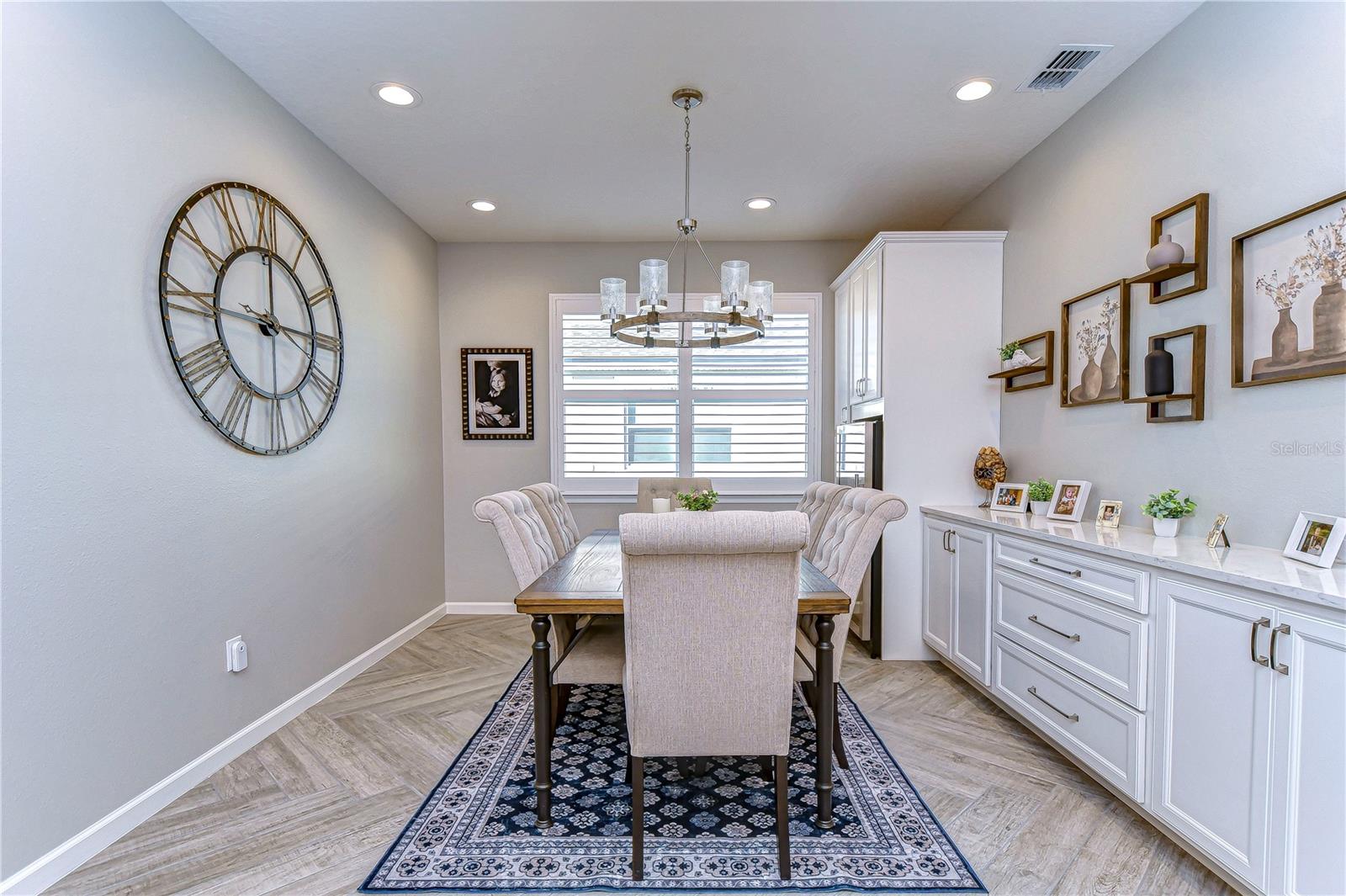 EXPANSIVE dining room features built in cabinets for storage and serving!