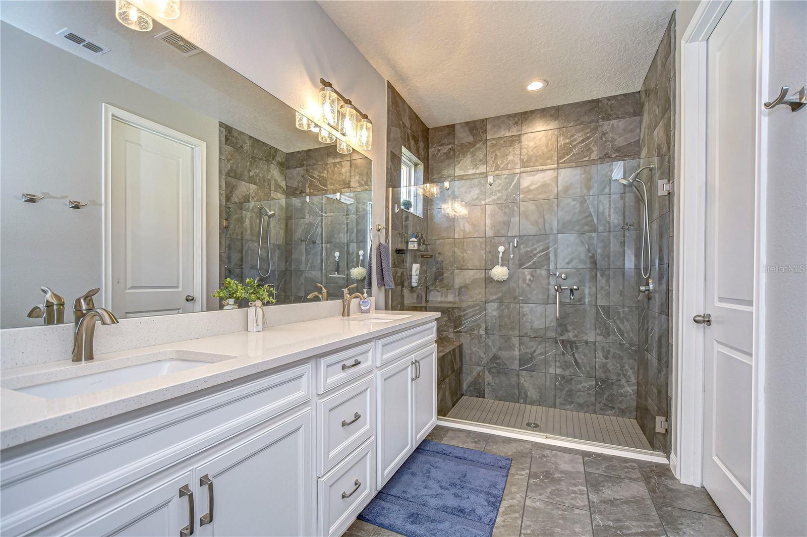 En-suite bath boasts dual sinks and updated cabinetry!