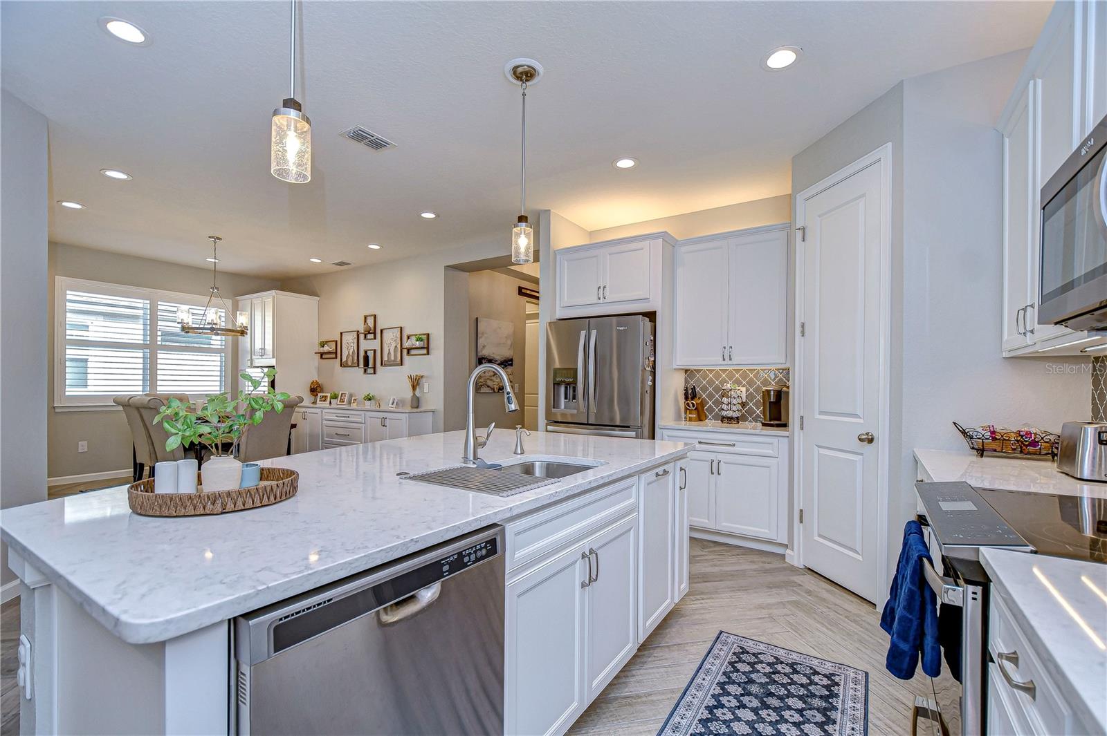 Kitchen features stainless steel appliances and gorgeous countertops!