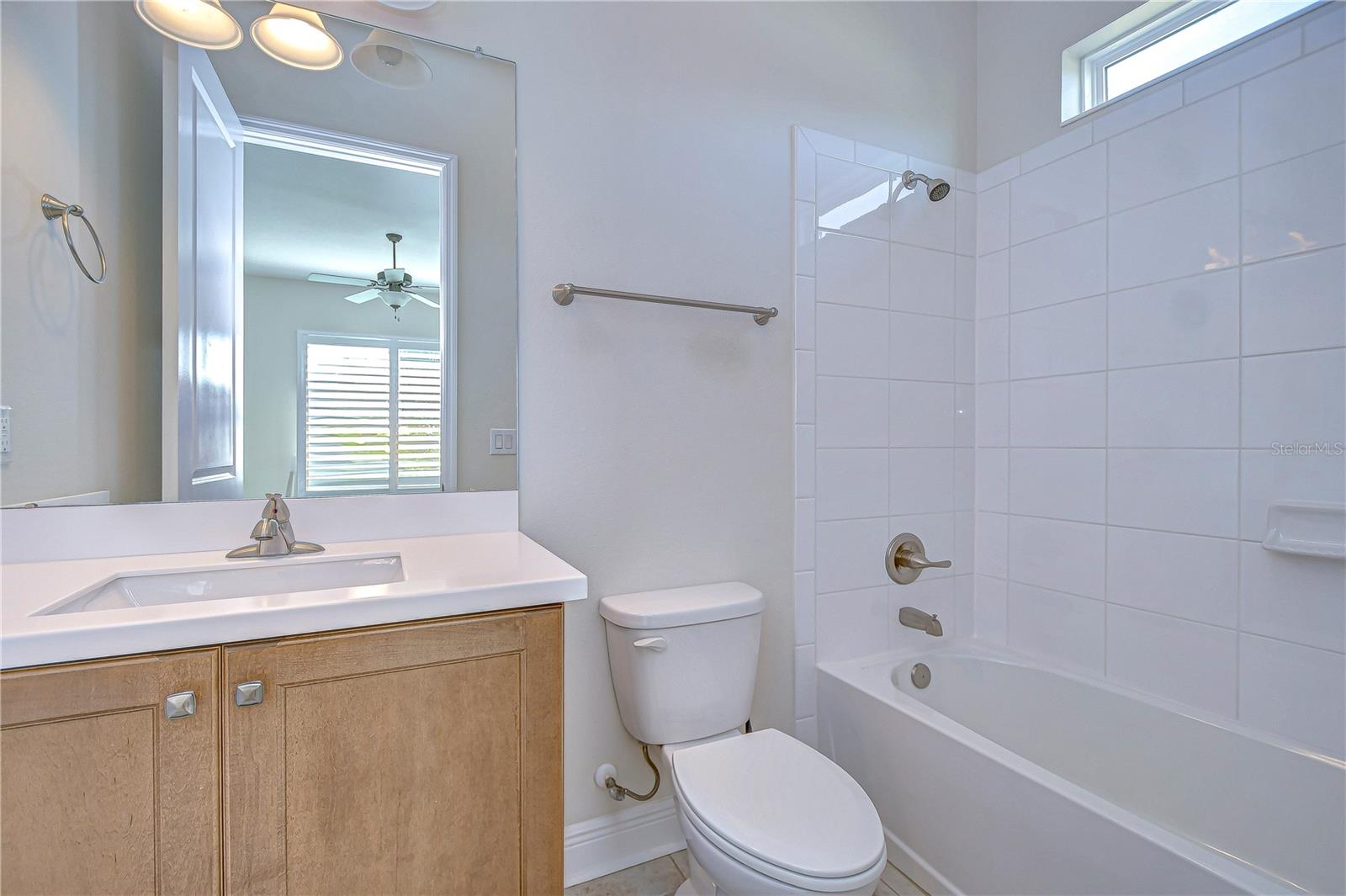 Second bathroom features tub and shower combination.