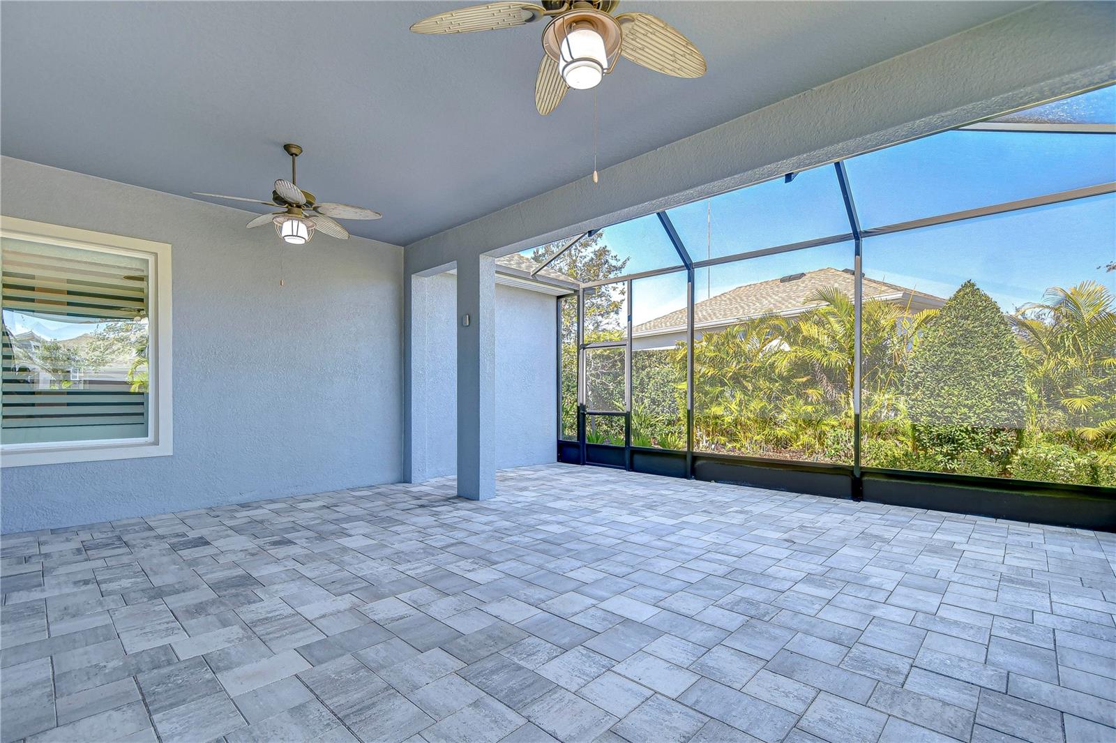 Beautiful covered patio with views of lush landscaping!