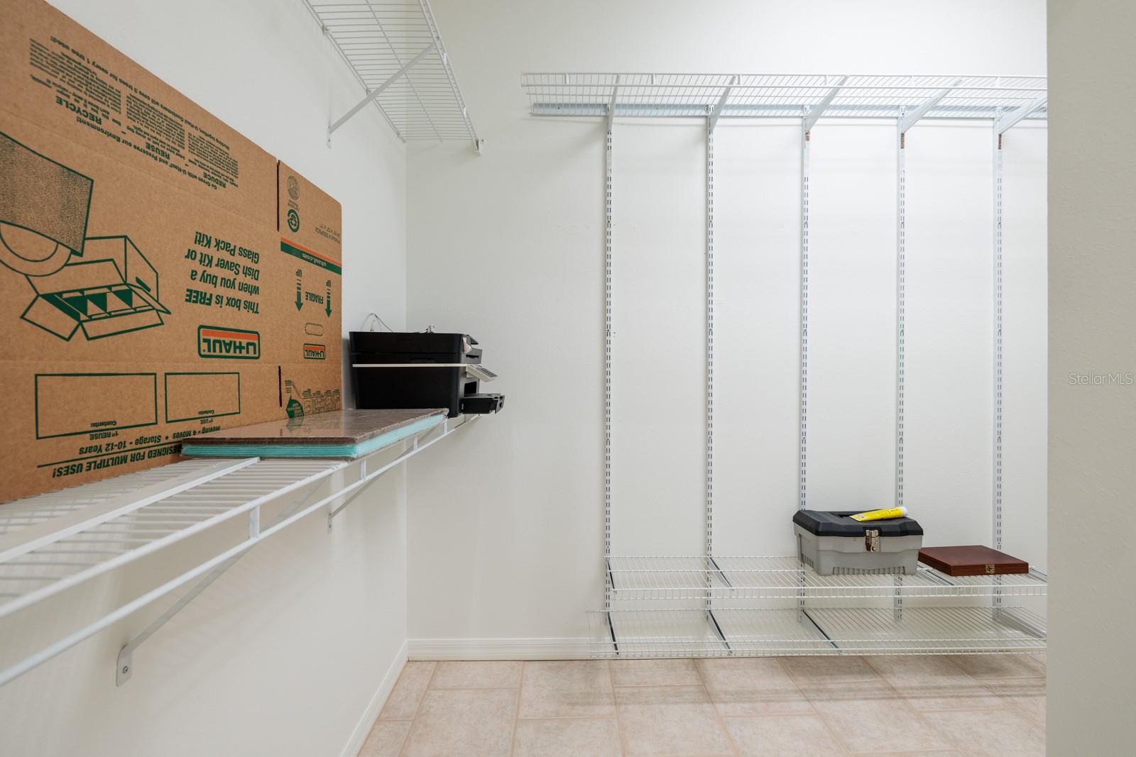 Extra large walk-in closet has ample storage for clothes and other items.