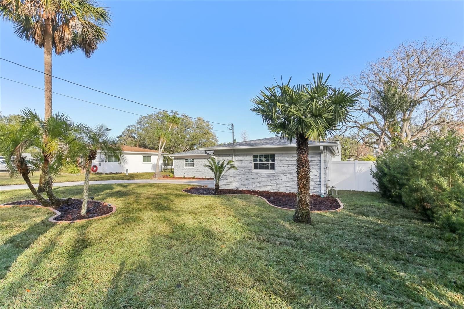 Front Yard w/ Mature Tropical Landscaping and New Sod