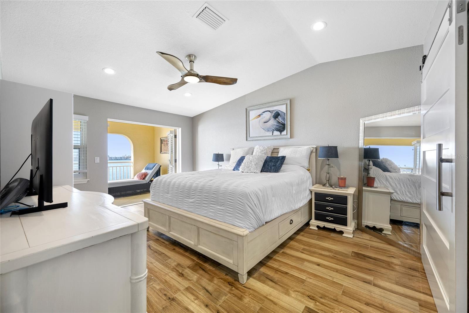 Primary Suite with sliding glass doors to waterfront balcony