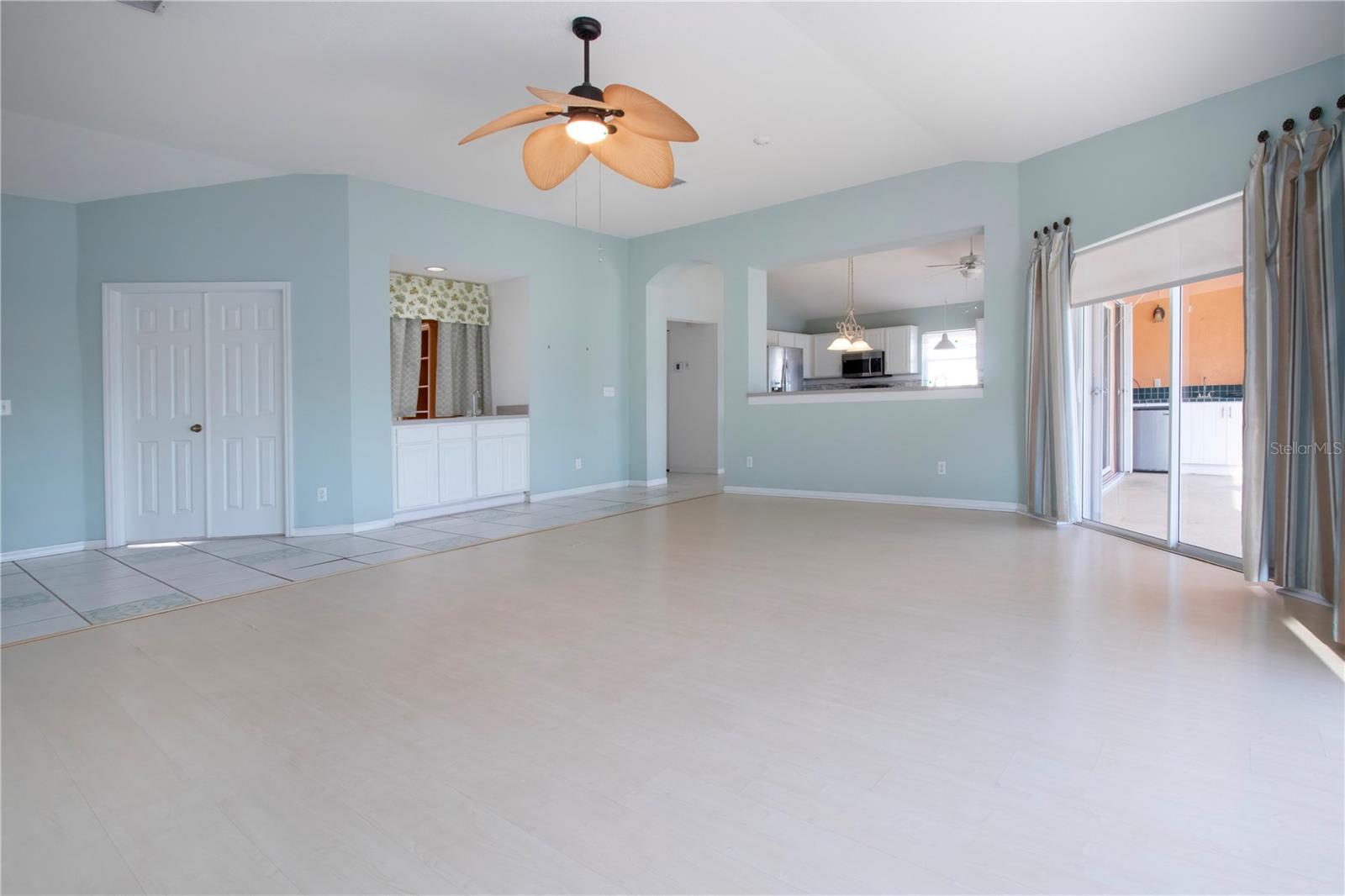 Great room w/double doors to Office, Wet bar, pass thru to Kitchen & sliders to pool area