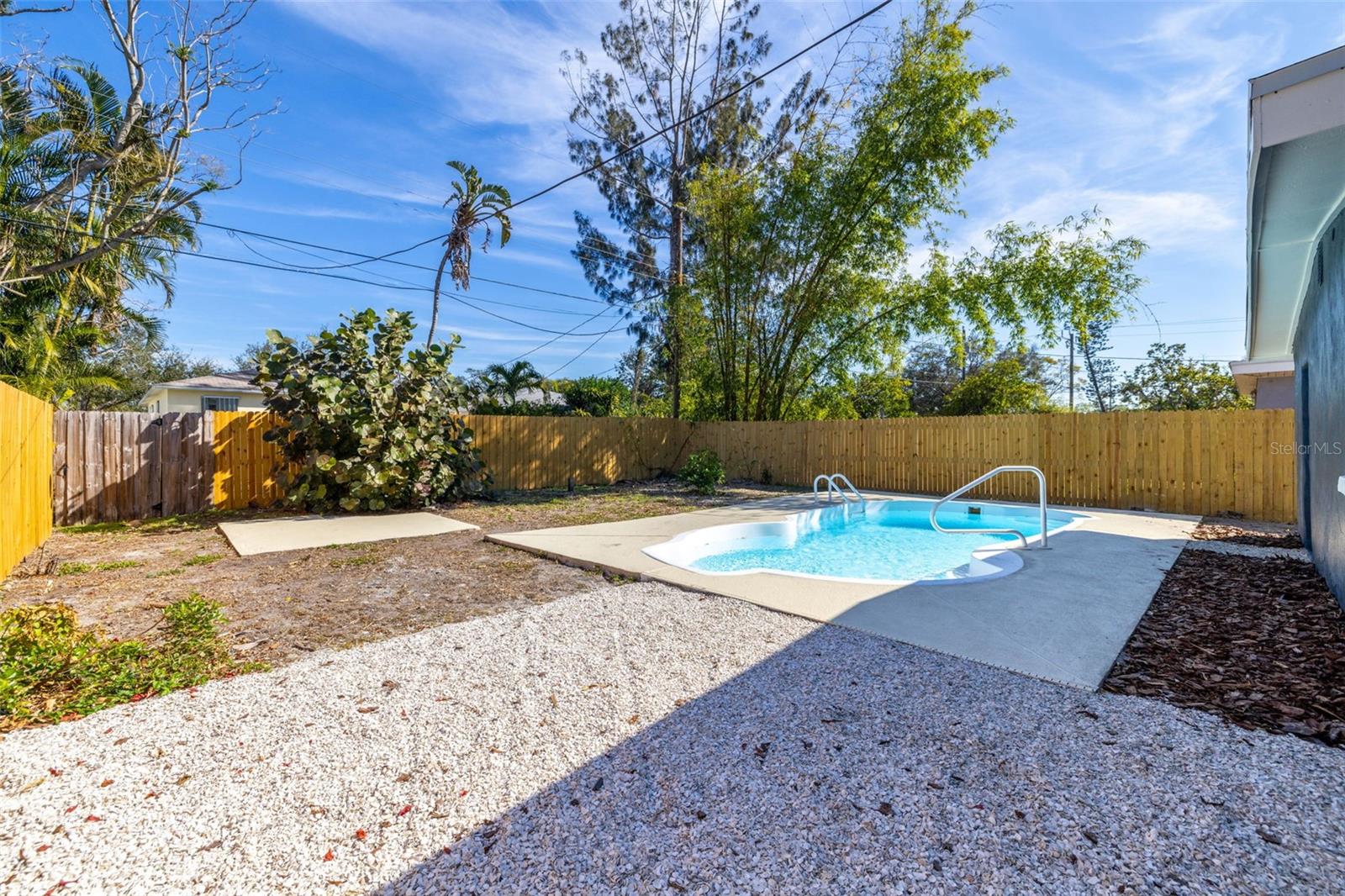 Large fenced backyard with pool