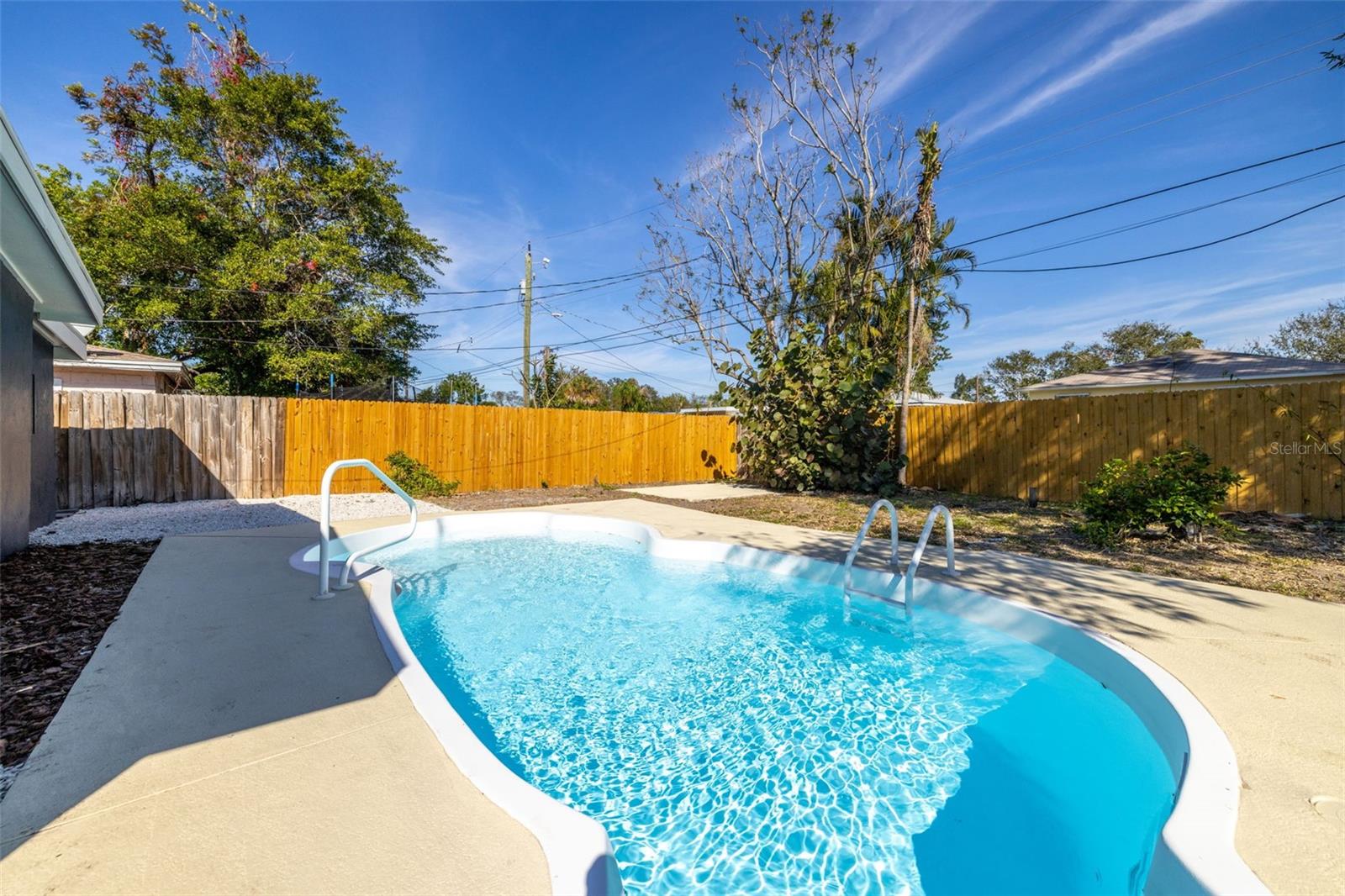 Large fenced backyard with pool