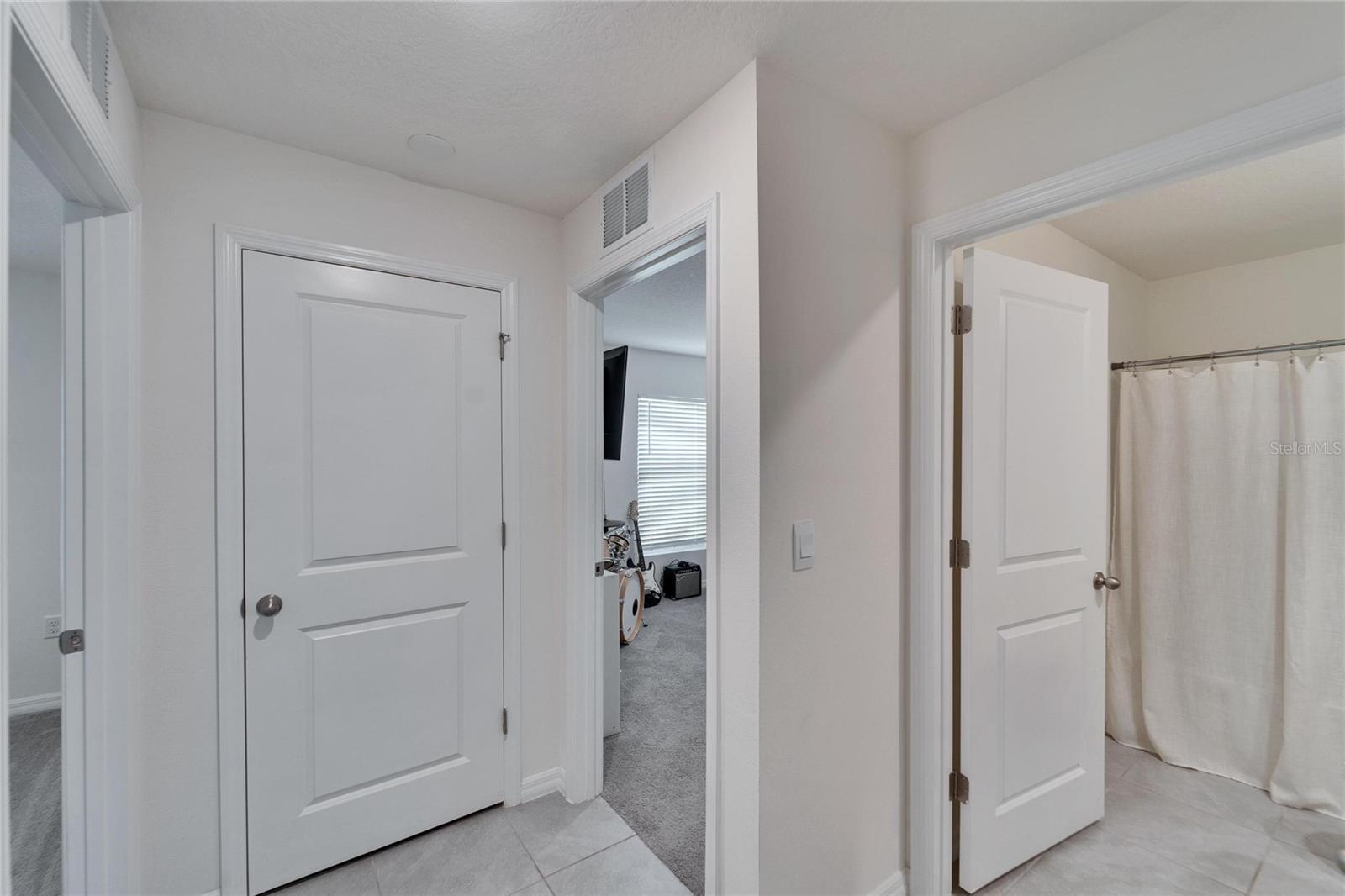 Hallway to guest bedrooms, second bathroom