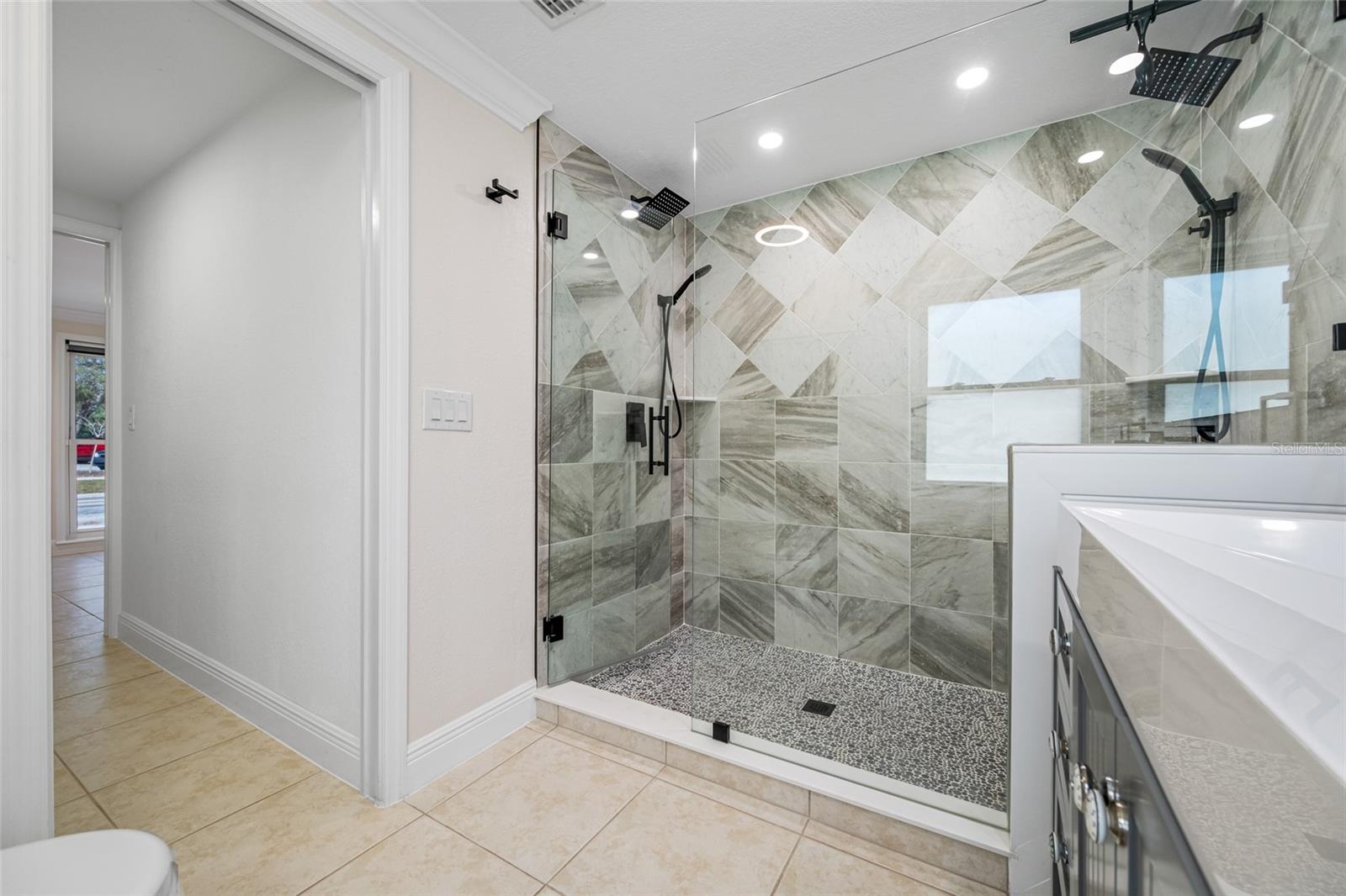 Primary Bathroom with elegant frameless glass walking shower