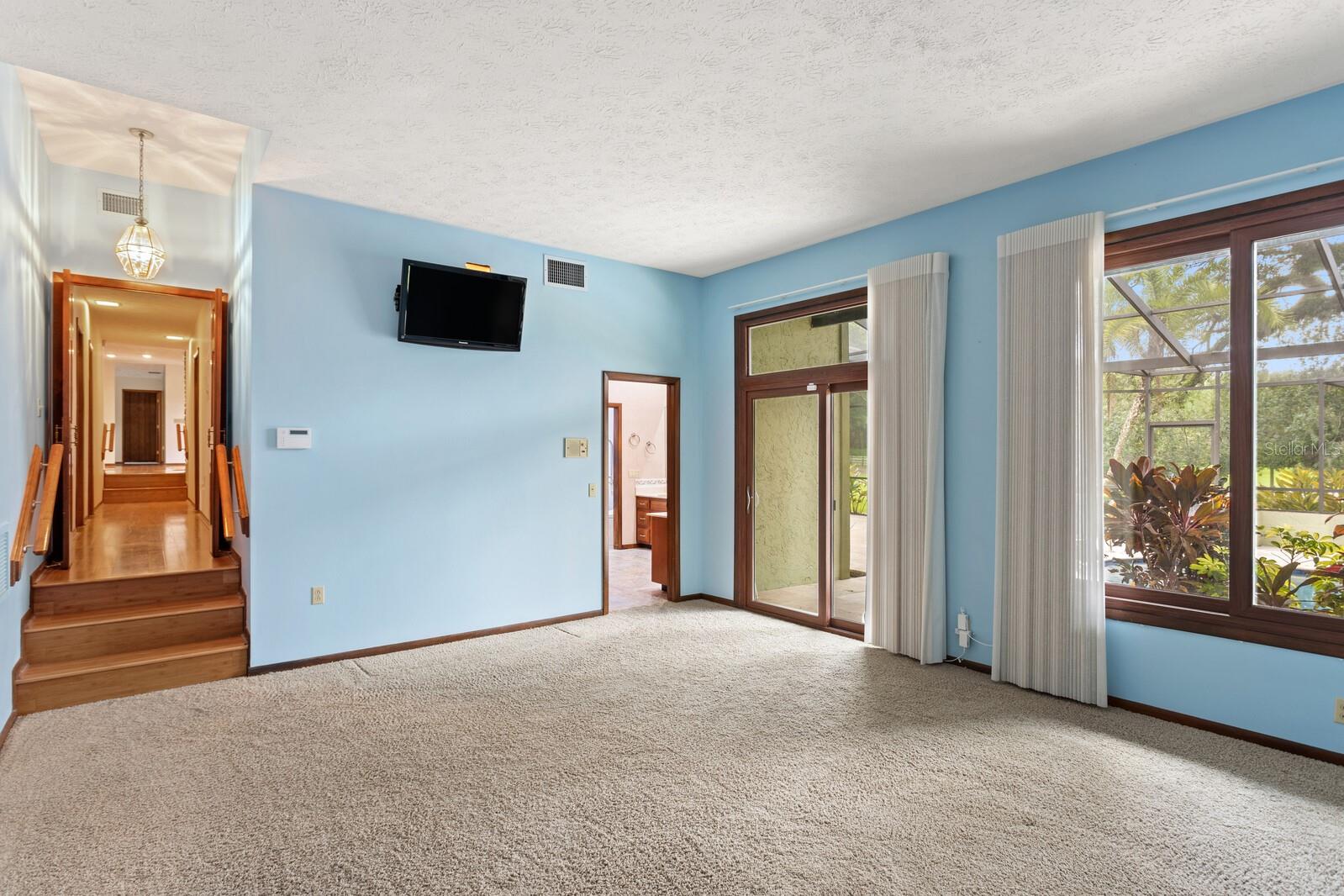 Primary bedroom features sliding doors to the lanai!