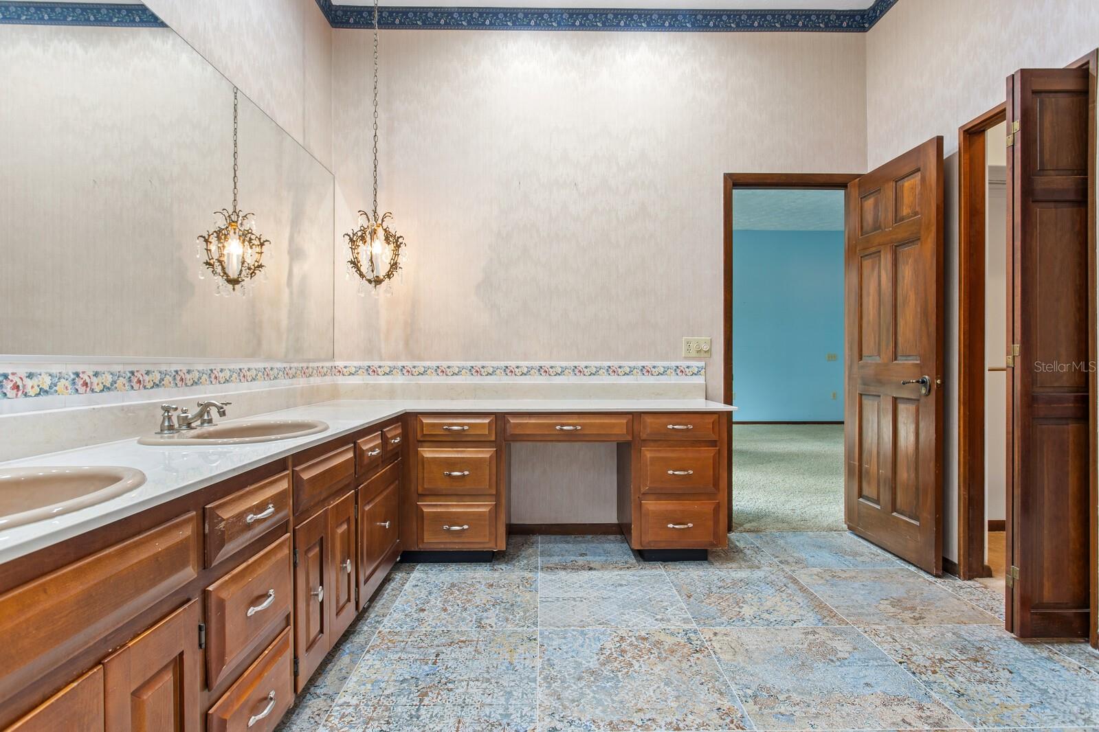 Primary bath is expansive featuring dual sinks and vanity space.