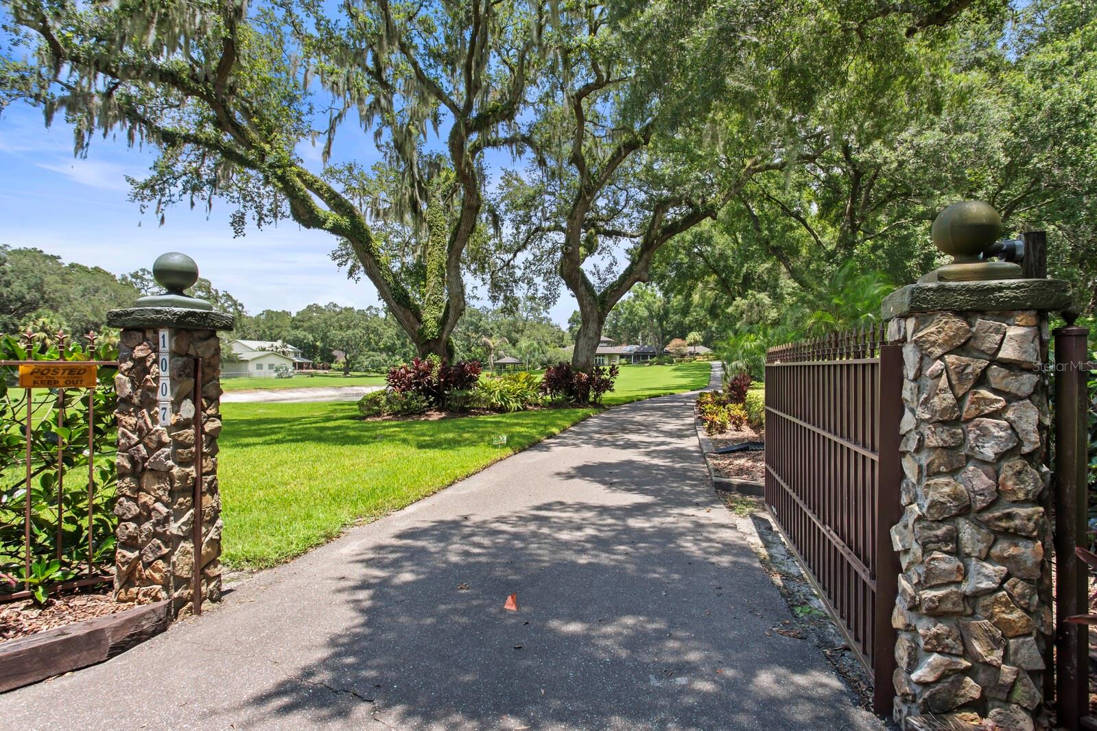 Gated entry under towering trees!