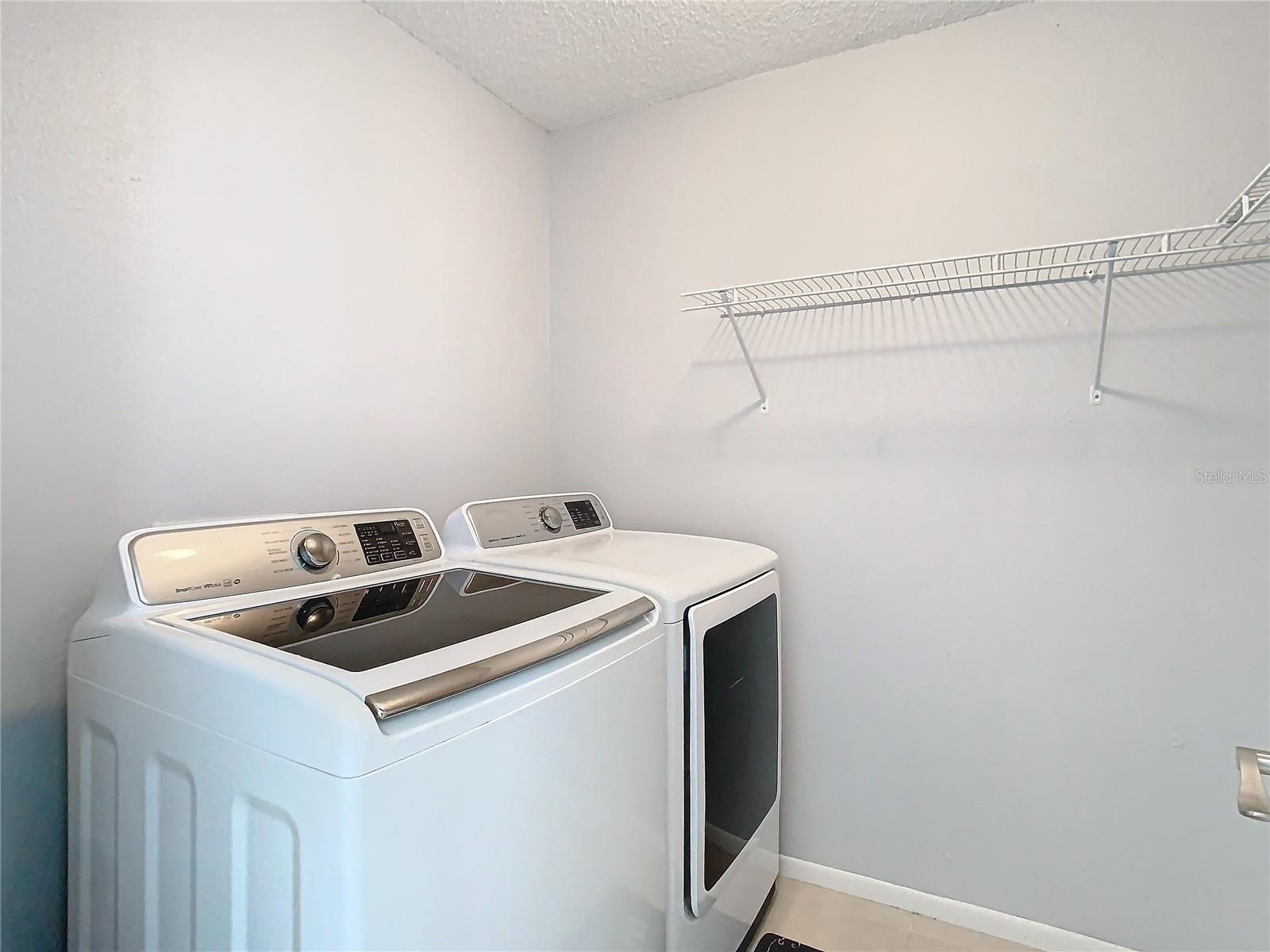 Spacious laundry room with wrap around L shaped rack