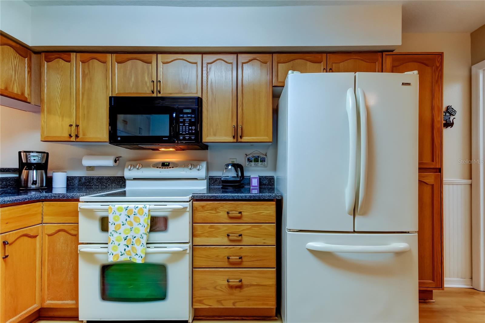 39. Kitchen (9.1' x 15.3') w Large Pantry Cabinet to the Right of Double Door Fridge!