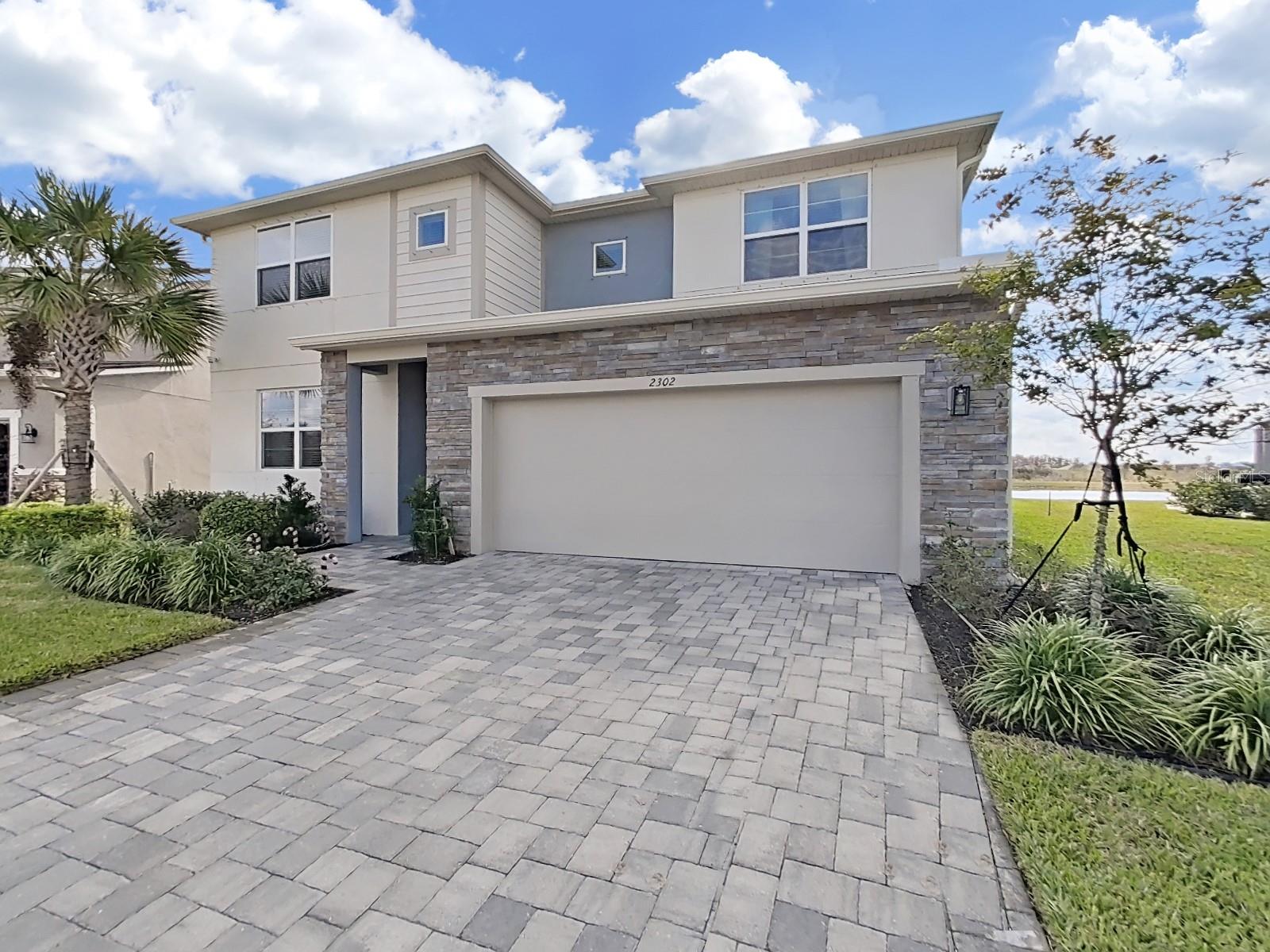 Brick paved driveway with 3 car tandem garage