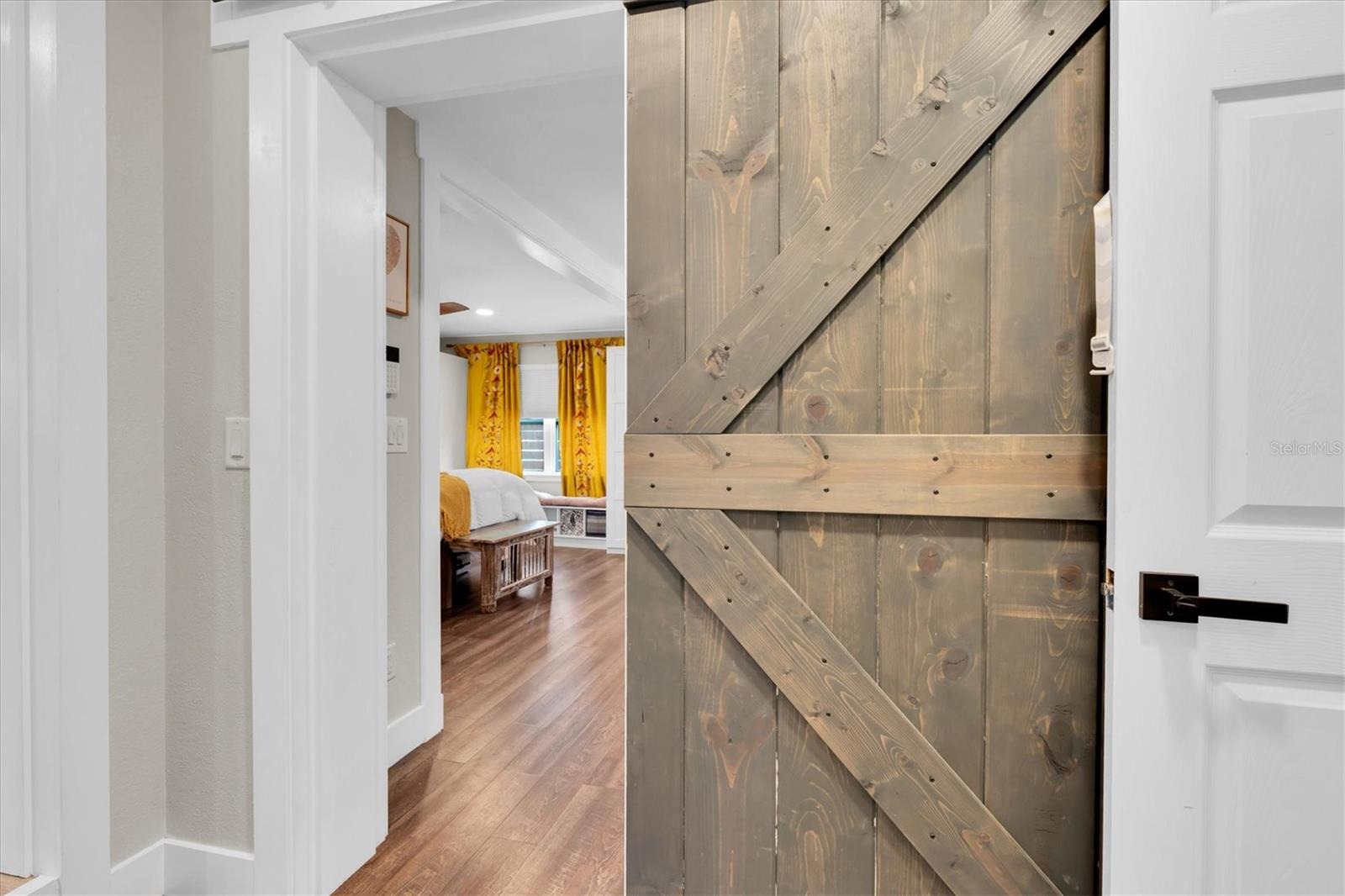 Beautiful Barn Doors from bathroom hallway into Primary Suite