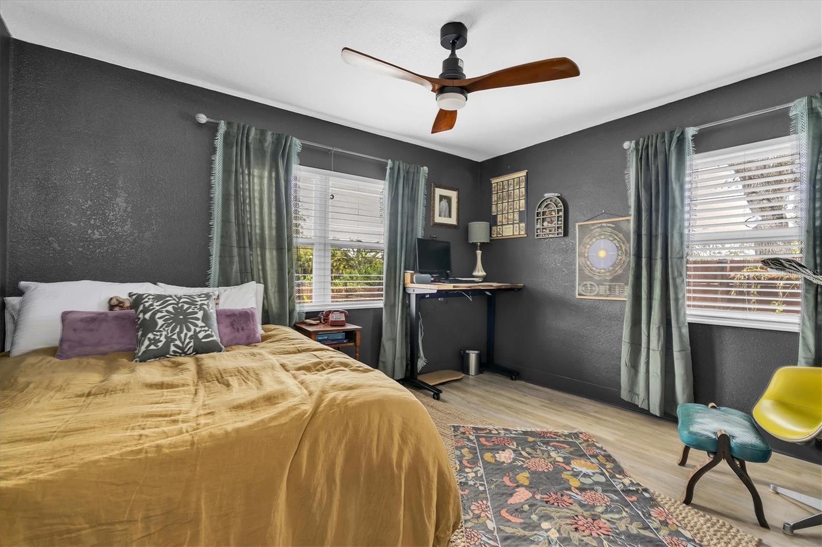 Second Bedroom has luxury vinyl tile, ceiling fan, and custom blinds.  This  split floor plan is ideal for family, guests, or home office space.