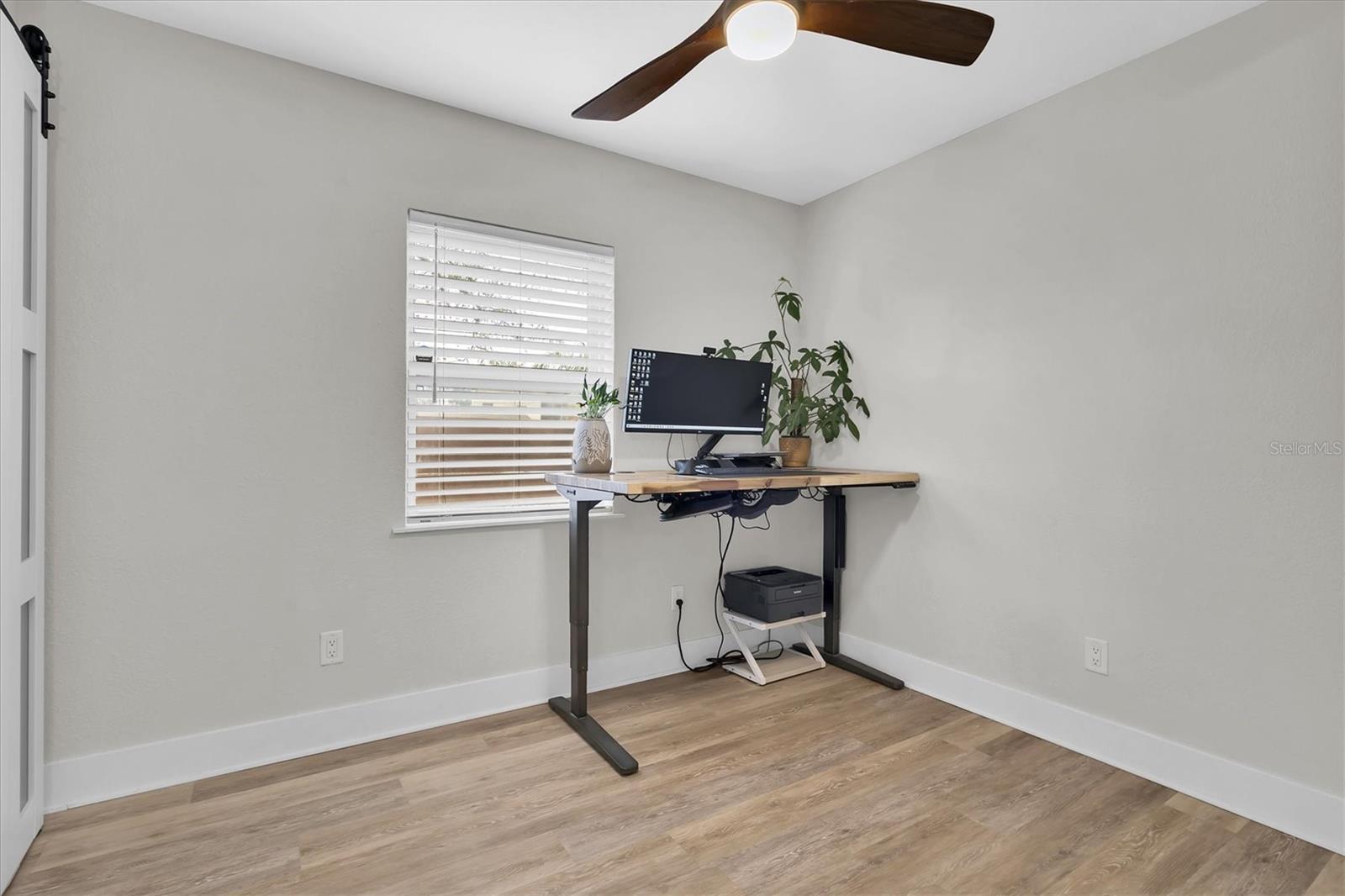 Third bedroom has luxury vinyl tile, ceiling fan, and custom blinds.  This  split floor plan is ideal for family, guests, or home office space.