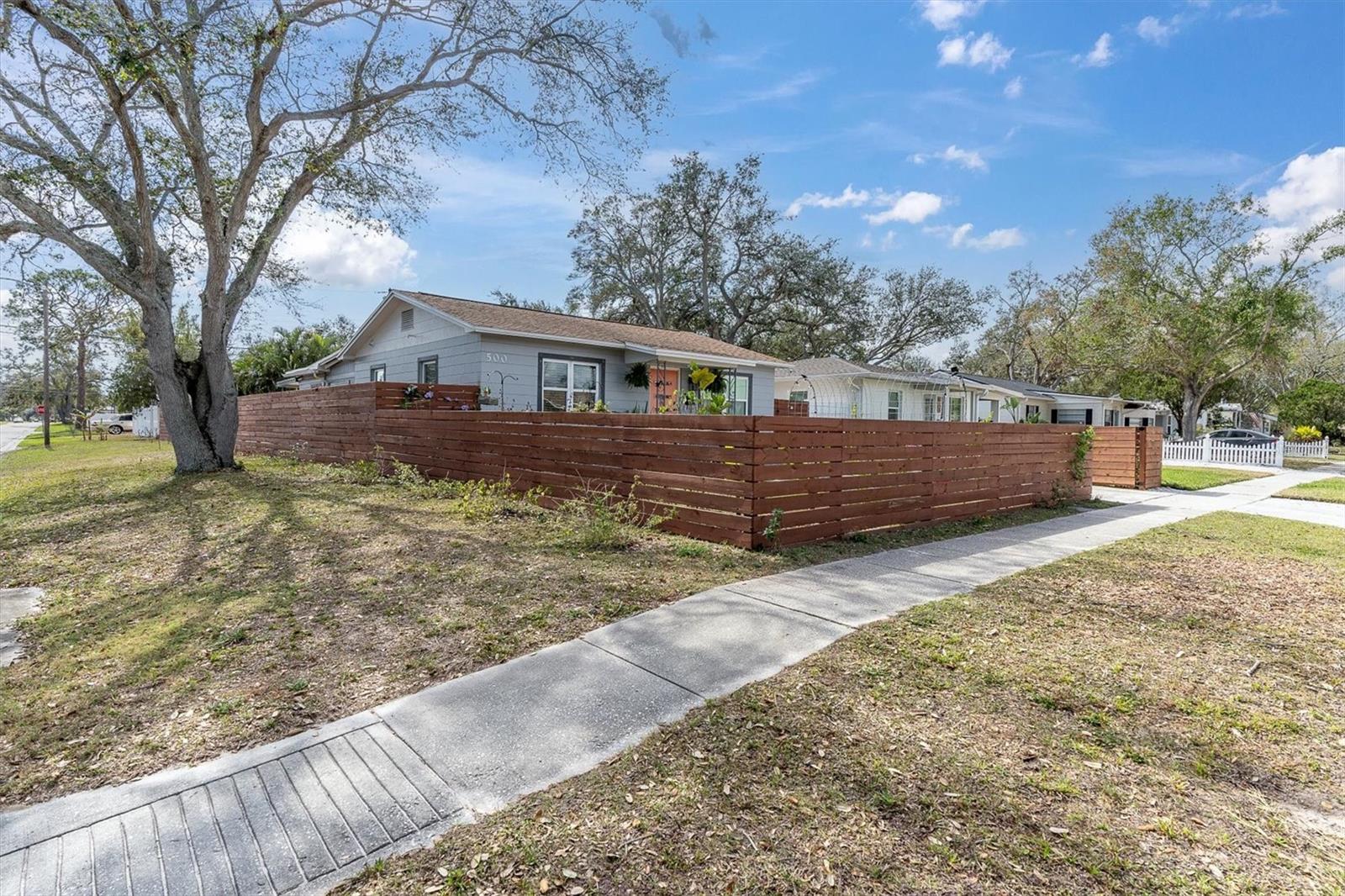 Corner lot with horizontal wood fence offering privacy around the entire property.  Plenty of parking with the driveway, alley in the back leading to two-car carport, and street parking also.