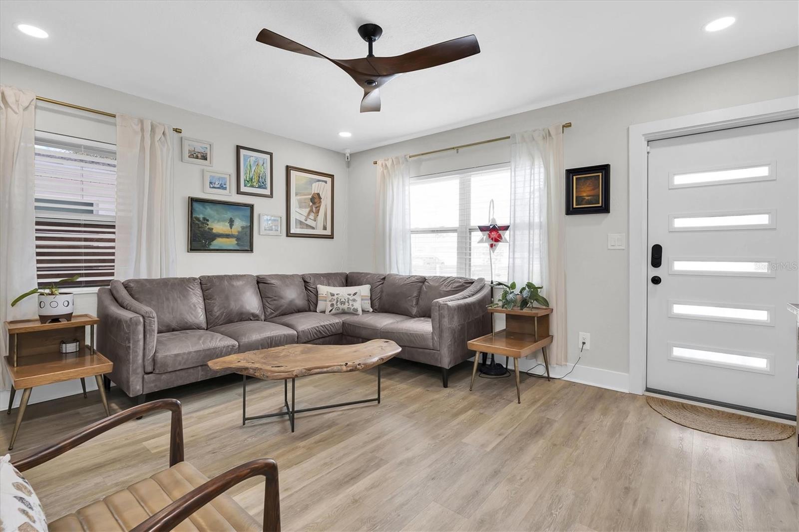 Living Room with Luxury Vinyl Tile, Celing Fan, Custom Blinds, and Recessed Lights