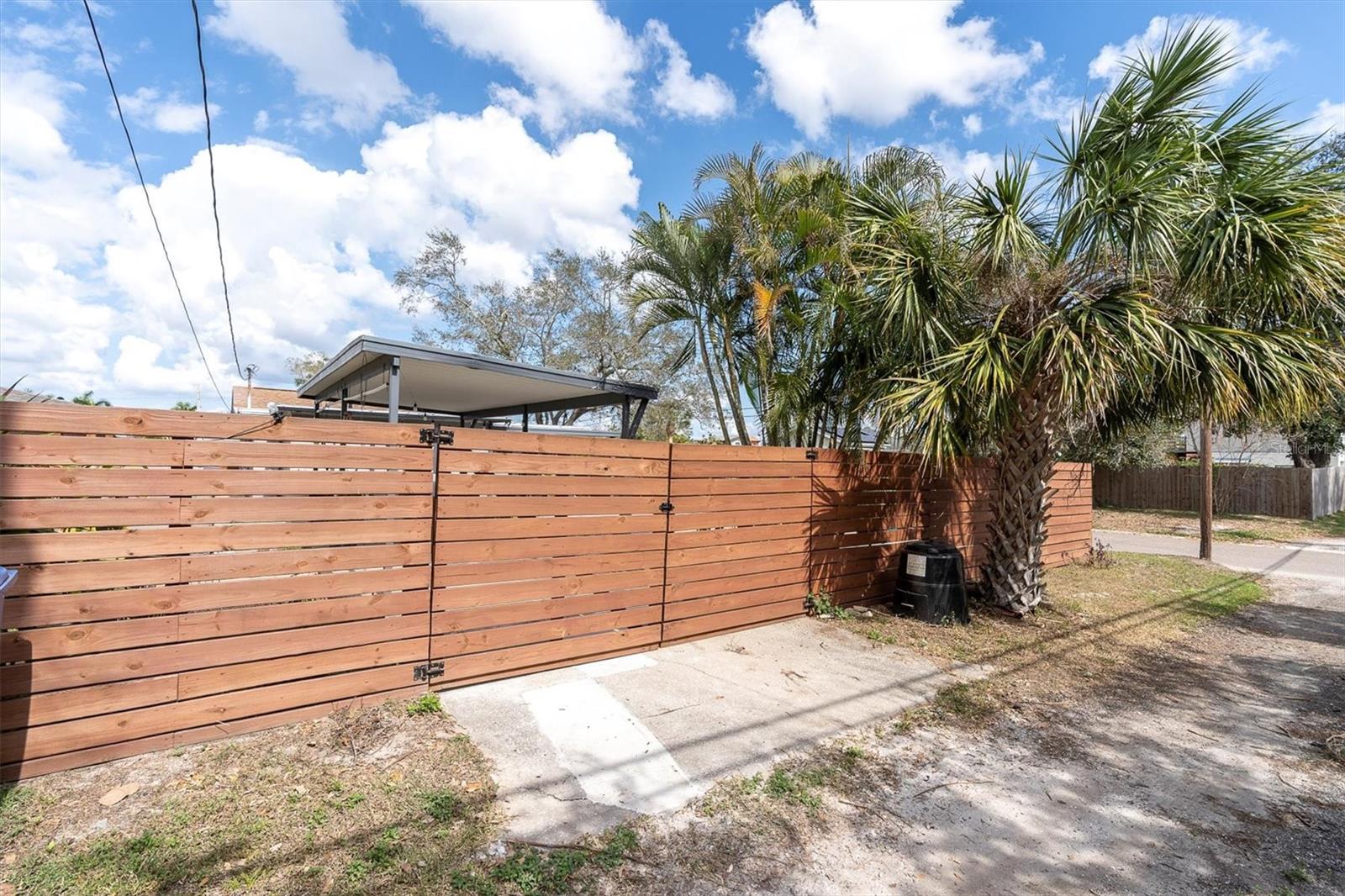 Back Alley with easy access to back yard and covered two-car carport.