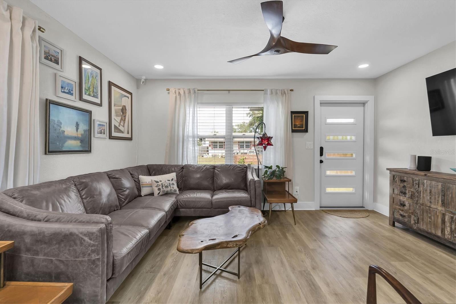 Living Room with Luxury Vinyl Tile, Celing Fan, Custom Blinds, and Recessed Lights