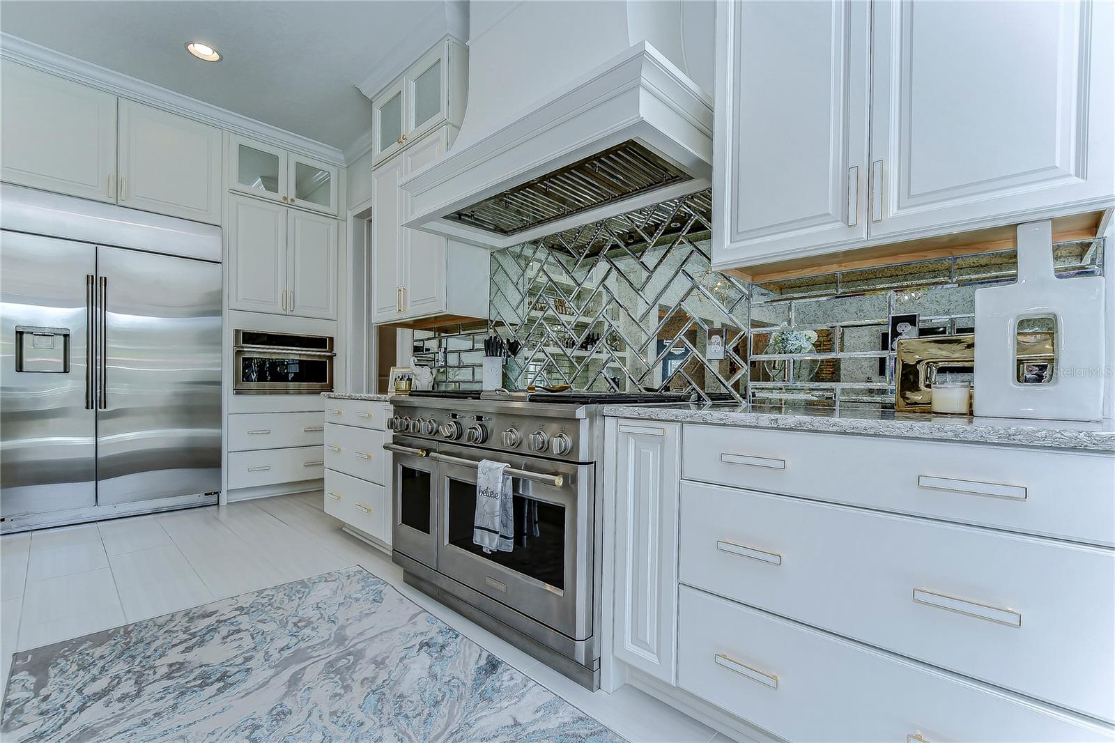 Indulge in culinary elegance with this gourmet kitchen, where high-end appliances meet sleek cabinetry and a captivating tiled backsplash.