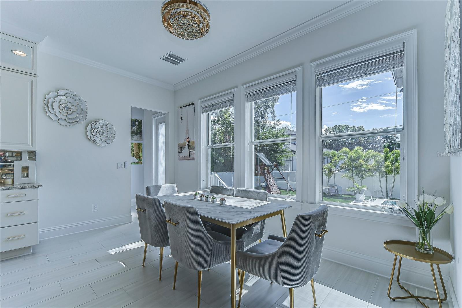 Bathe in serenity as sunlight floods this exquisite dining area, where elegance meets functionality.