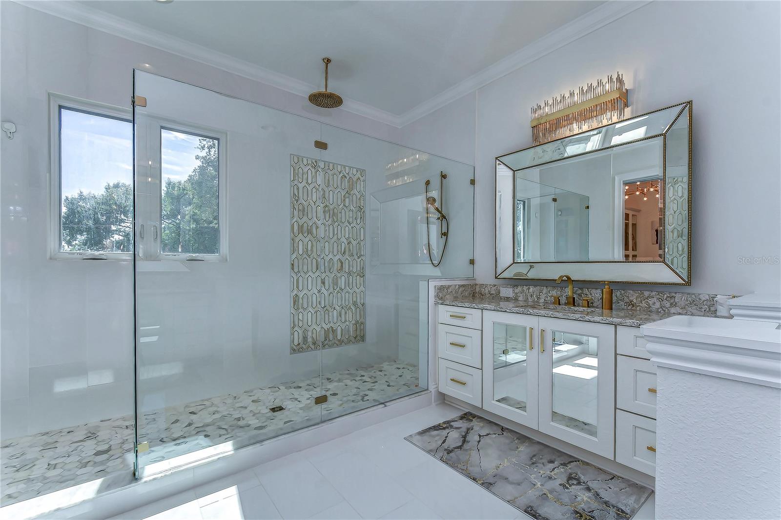 Step into this spa-like oasis where elegance meets serenity. Highlighted by exquisite tile work and opulent fixtures, this luxurious bathroom is your perfect retreat.