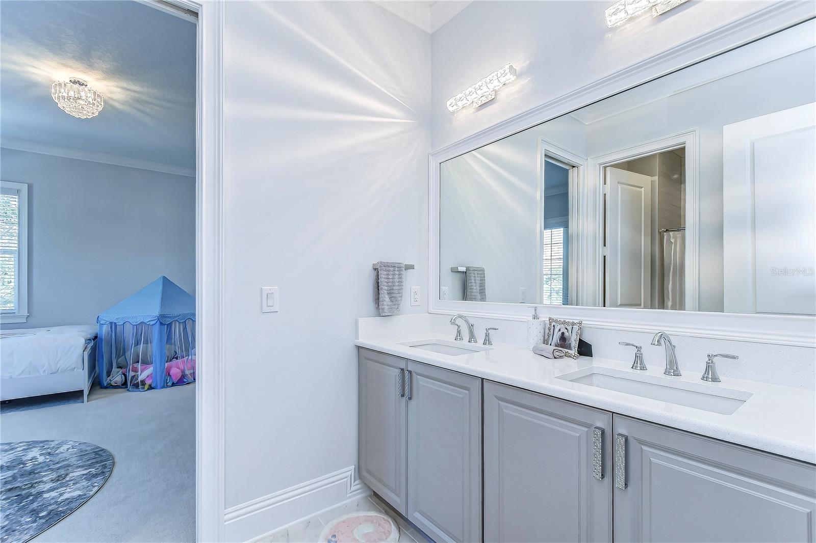 Discover serenity in this elegant double-vanity bathroom, where sleek design meets functional tranquility.