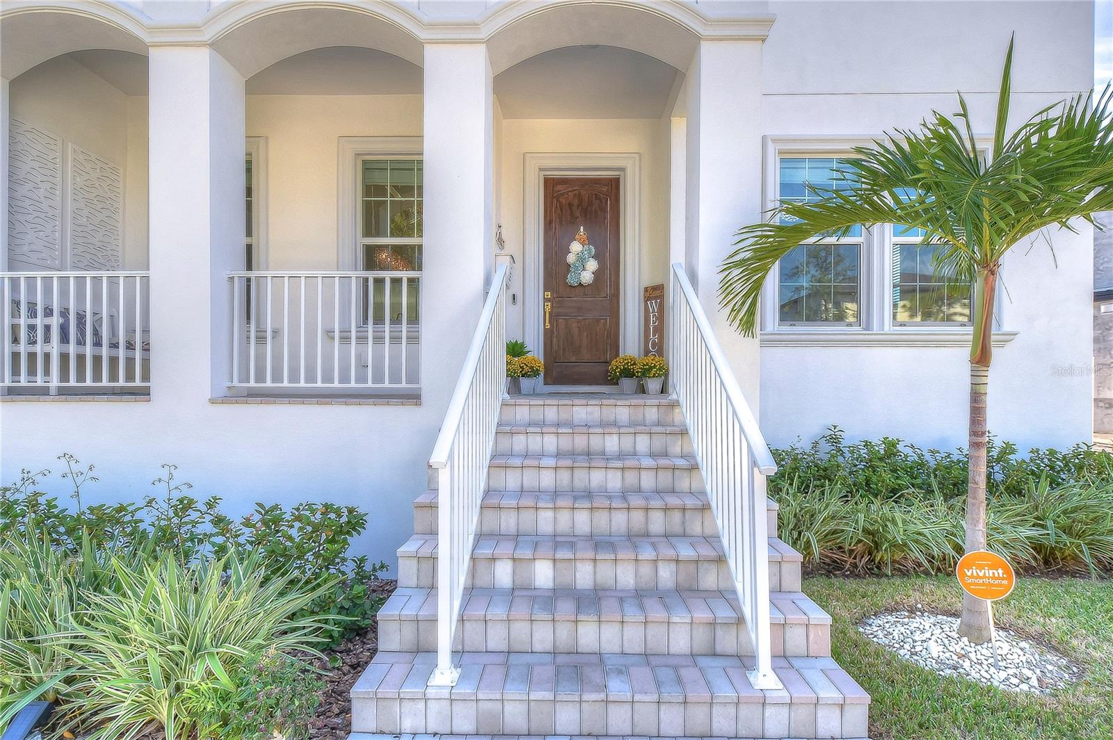 Step into elegance with this stunning entrance. Accented by lush greenery and a welcoming porch, it sets the tone for the luxurious living within.