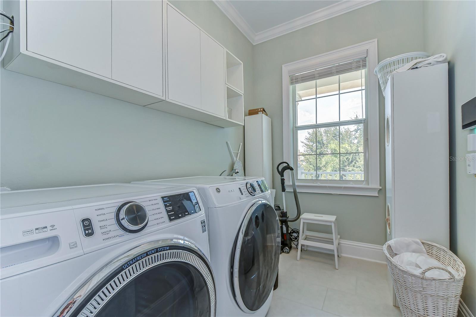 Efficiency meets elegance in this pristine laundry oasis