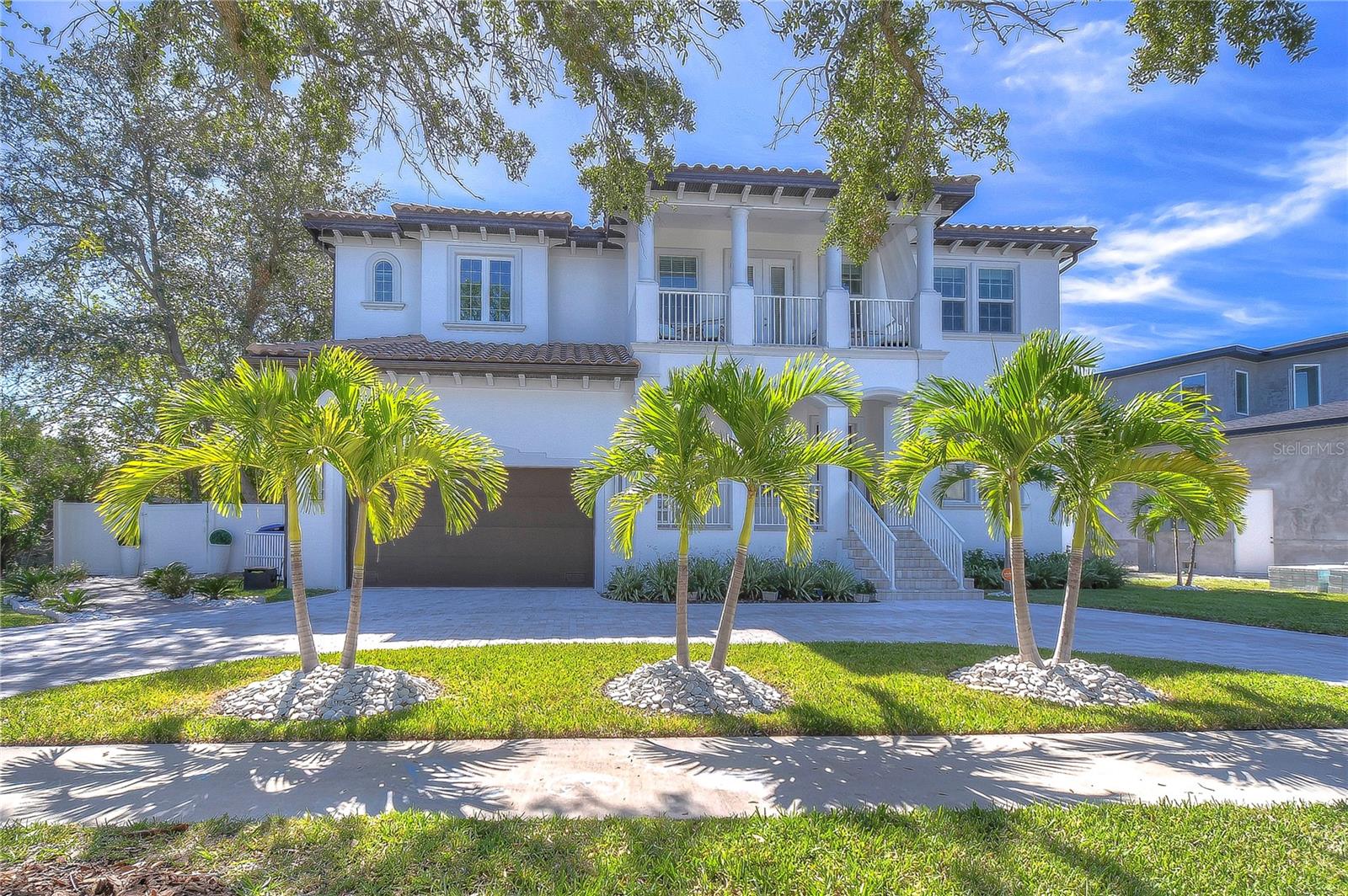 Elegant retreat with lush palm landscaping and timeless architectural charm.