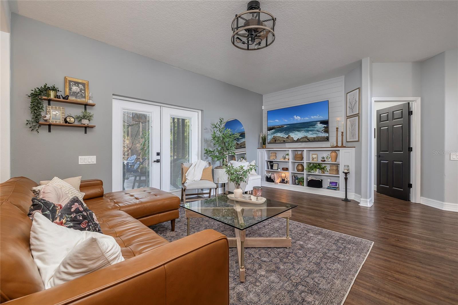 Living Room Features Custom Built-ins and views of the Pool