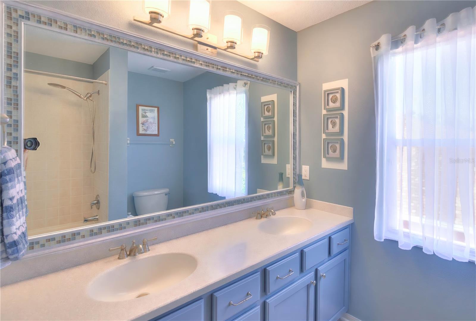 Updated full bath 3 features a tub/shower combo, dual sinks and a linen closet.