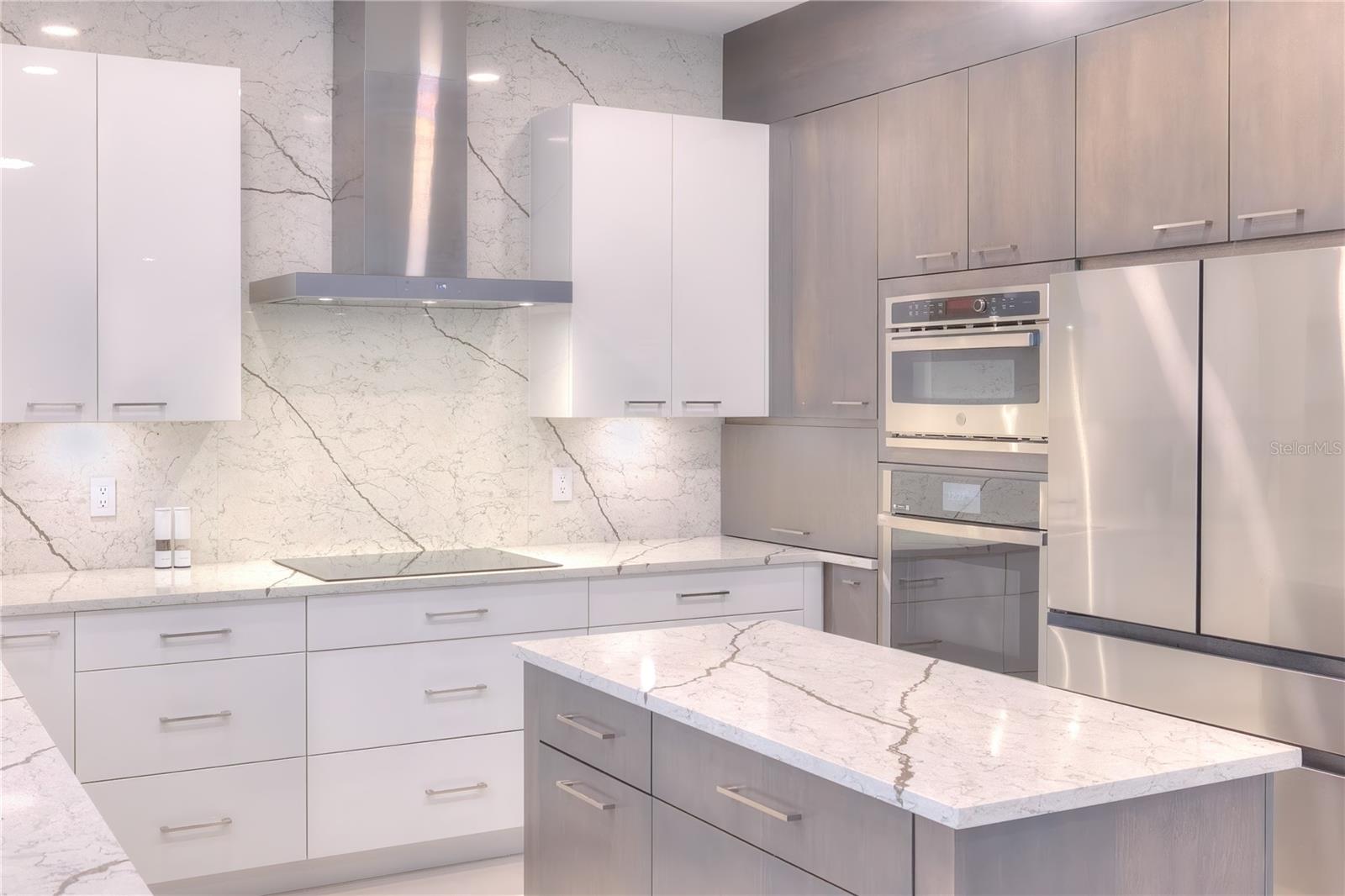 Feast your eyes on this NEW KITCHEN incl cabinets, quartz counters &  backsplash, appliance garage with outlets, induction counter top cooking & more!